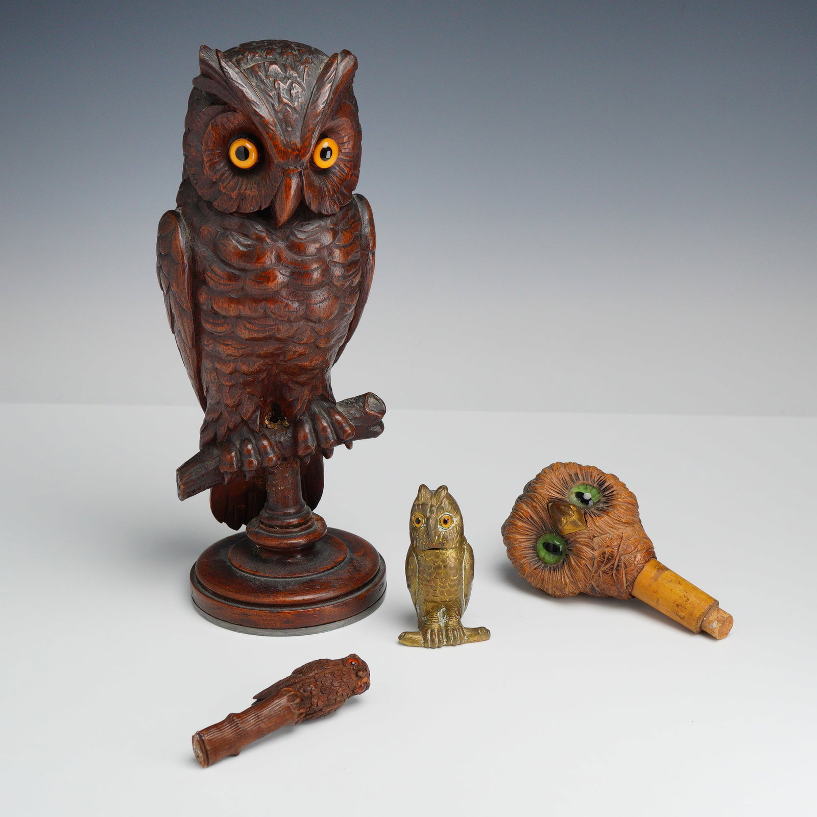 4pc Owl Themed Figurines, Jewelry Box, and Cane Handle: This collection consists of four decorative and functional owl-themed items. The primary piece is a large hand-carved wooden owl sculpture, attributed to the German Black Forest style of the early 20t