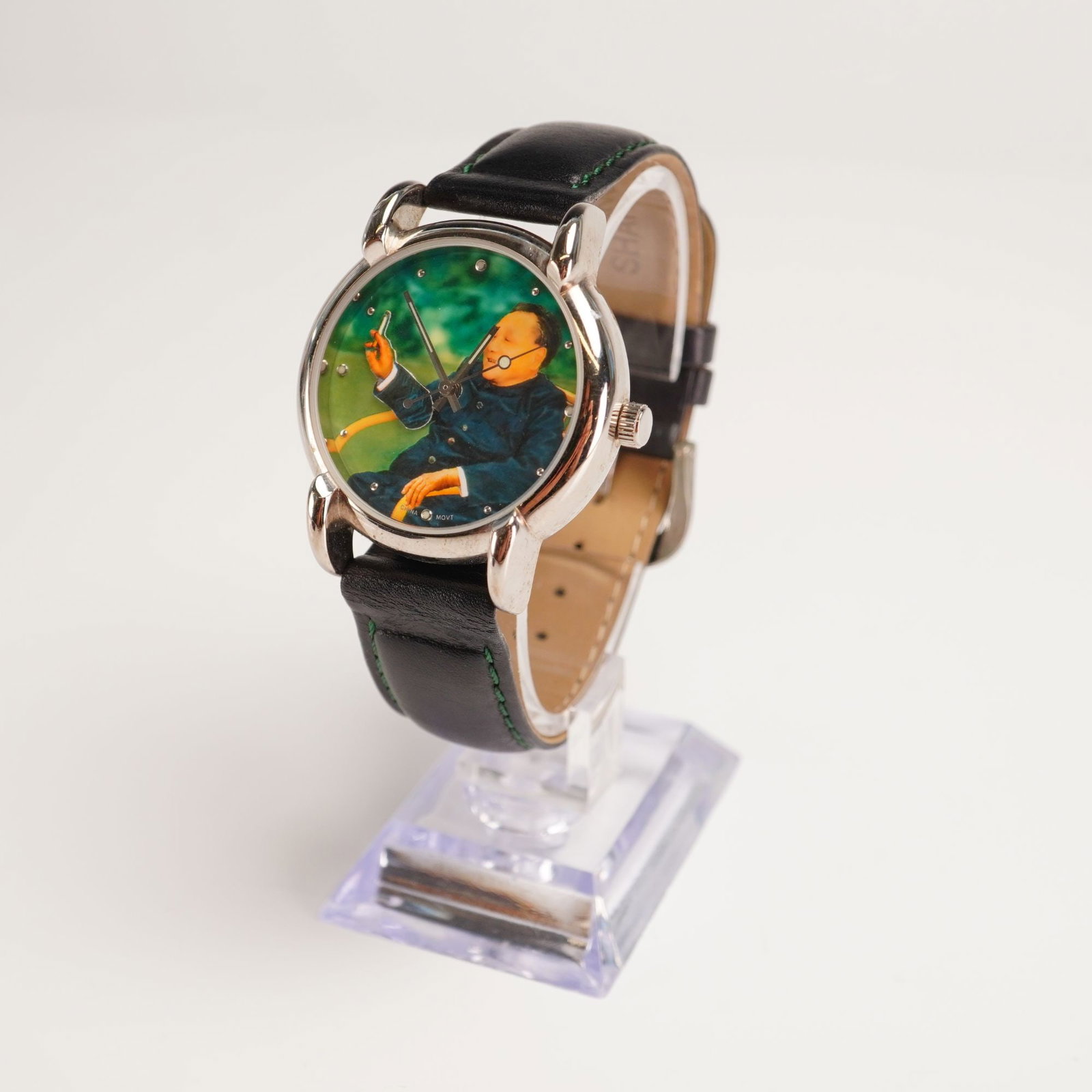 Shanghai Tang Unisex Self Winding Watch, Chairman Mao: 17 jewel Made and Assembled in China; Full color Chairman Mao display face; Black leather band; Shanghai Tang impressed mark on band. Dimensions: 9"L Weight: 1.8 oz.