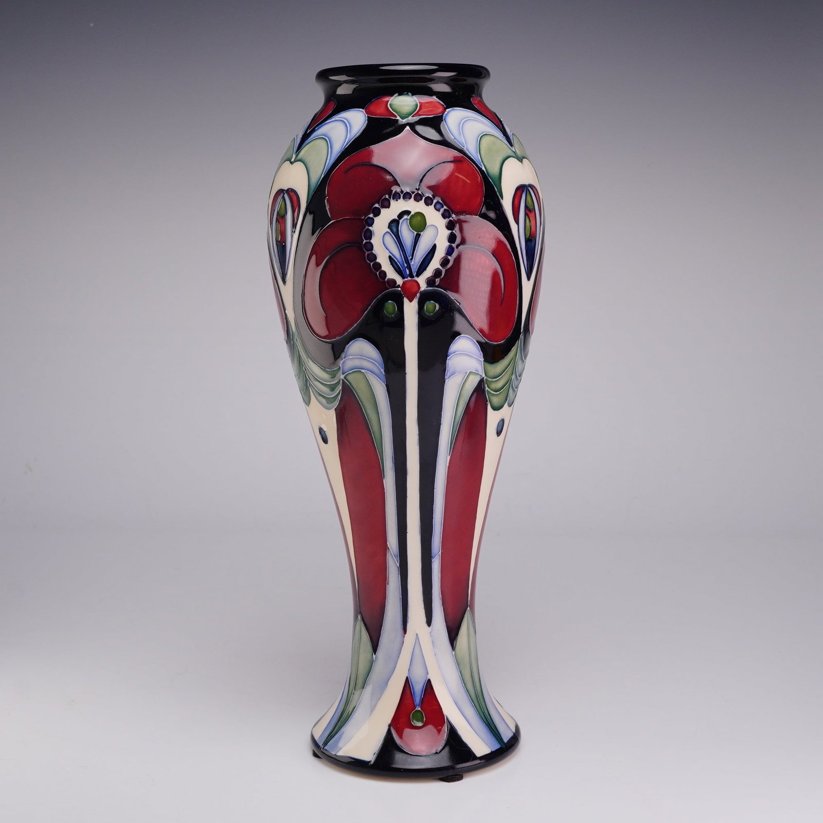 Moorcroft Pottery by Rachel Bishop Vase, Field of Hope: This Moorcroft earthenware vase features the Tribute to Charles Rennie Mackintosh pattern designed by Rachel Bishop. The vessel is characterized by a tall, slender form with an elongated ovoid body th