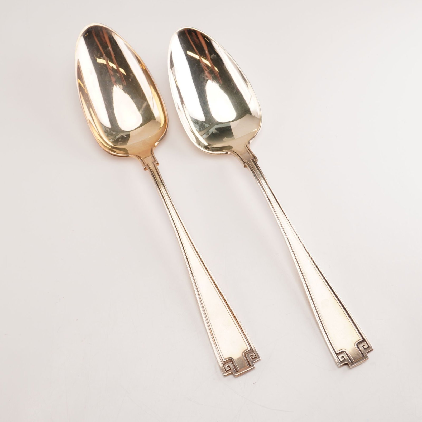 2pc Gorham Sterling Silver Oval Dessert Spoons, Etruscan: Pair of 2 Gorham sterling silver oval dessert spoons in the Etruscan pattern. Crafted between 1913 and 1991, Gorhams Etruscan flatware reflects a Greco-Roman revival design defined by its balanced sym