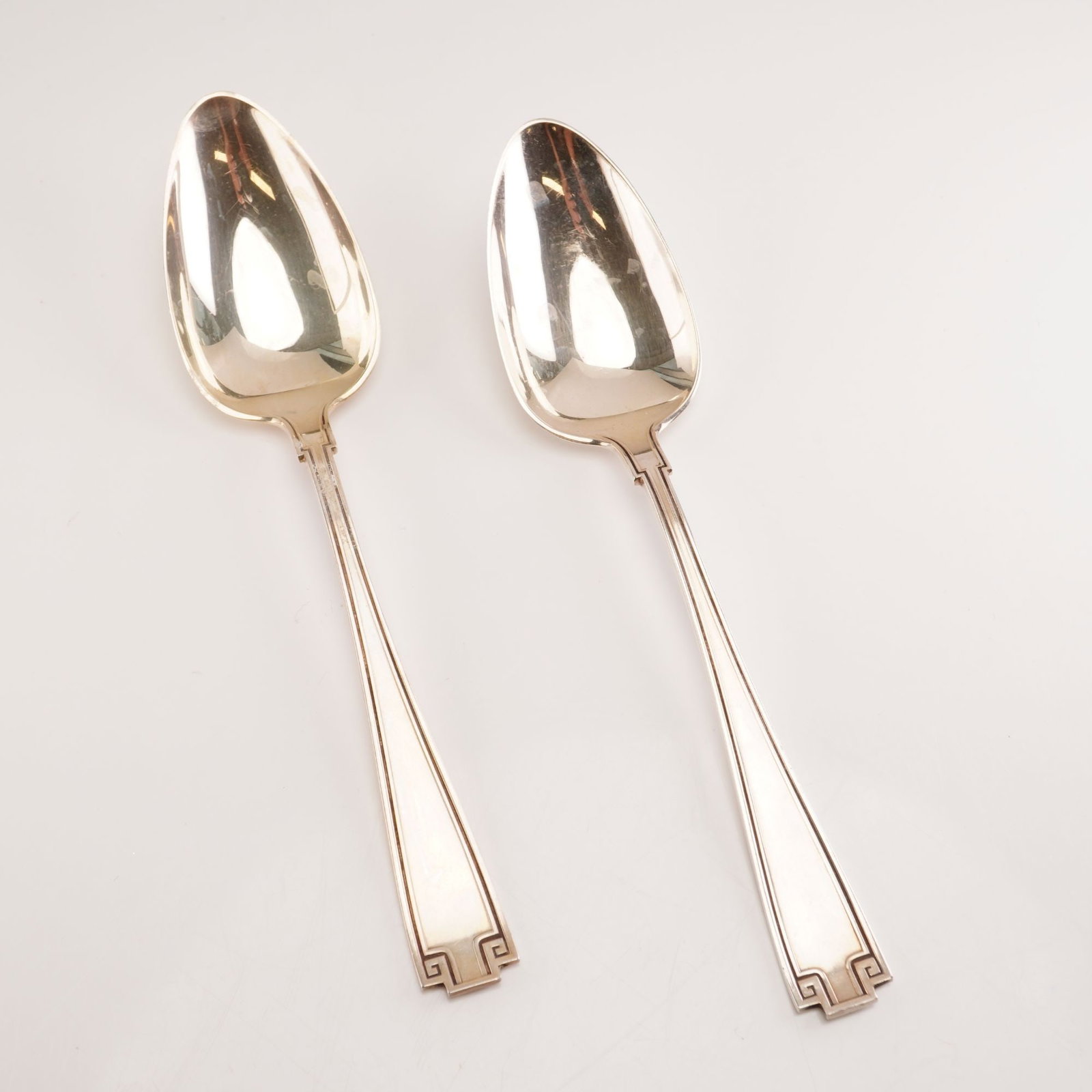2pc Gorham Sterling Silver Oval Dessert Spoons, Etruscan: Pair of 2 Gorham sterling silver oval dessert spoons in the Etruscan pattern. Dating from Gorhams production run of 1913 to 1991, this celebrated design reflects a Greco-Roman revival style characteri