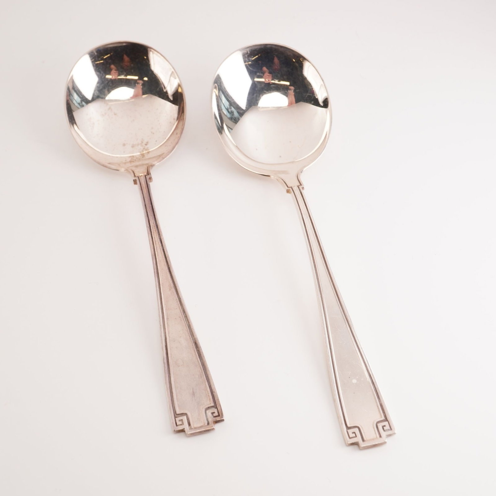 2pc Gorham Sterling Silver Round Soup Spoons, Etruscan: Gorham Etruscan flatware, produced from 1913 to 1991, is a Greco-Roman revival design defined by its balanced symmetry and classic Greek key motif. Introduced in the early 20th century, the pattern is