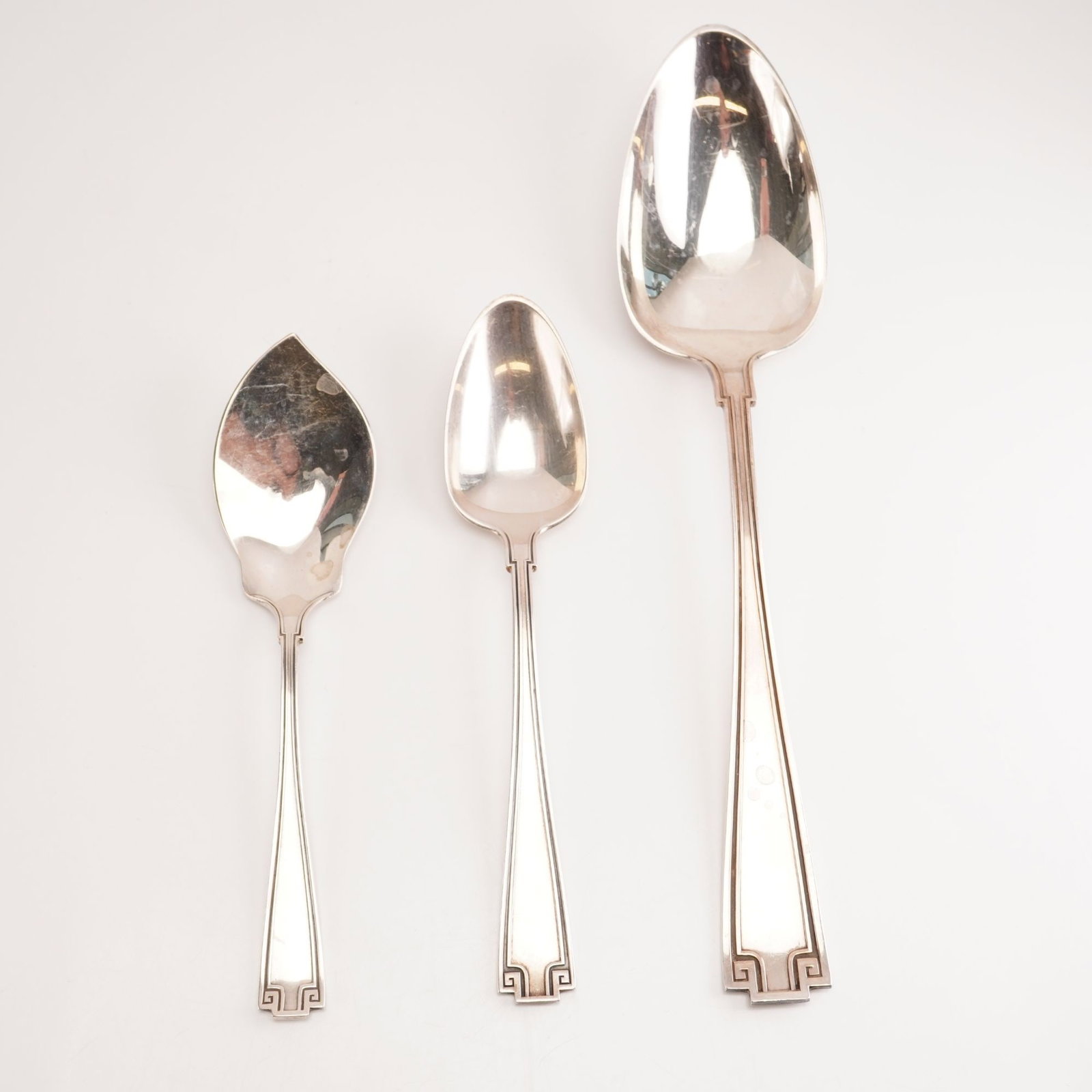 3pc Gorham Sterling Silver Serving Spoons, Etruscan: This collection features three pieces: a serving spoon, a five o'clock teaspoon, and a small jelly server. Gorham's Etruscan flatware, produced between 1913 and 1991, is a Greco-Roman revival design d