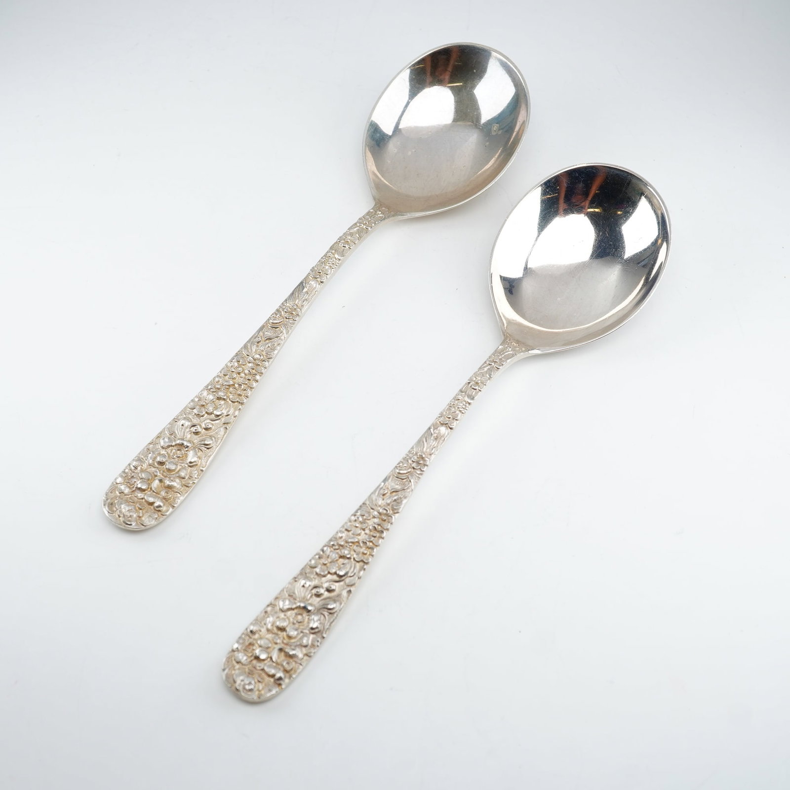 2pc Kirk Stieff Sterling Silver Round Bowl Soup Spoons, Stieff Rose: Set of two Kirk Stieff sterling silver soup spoons featuring round bowls in the classic Stieff Rose pattern. First introduced in 1892, this design is noted for its ornate floral repousse handle decora