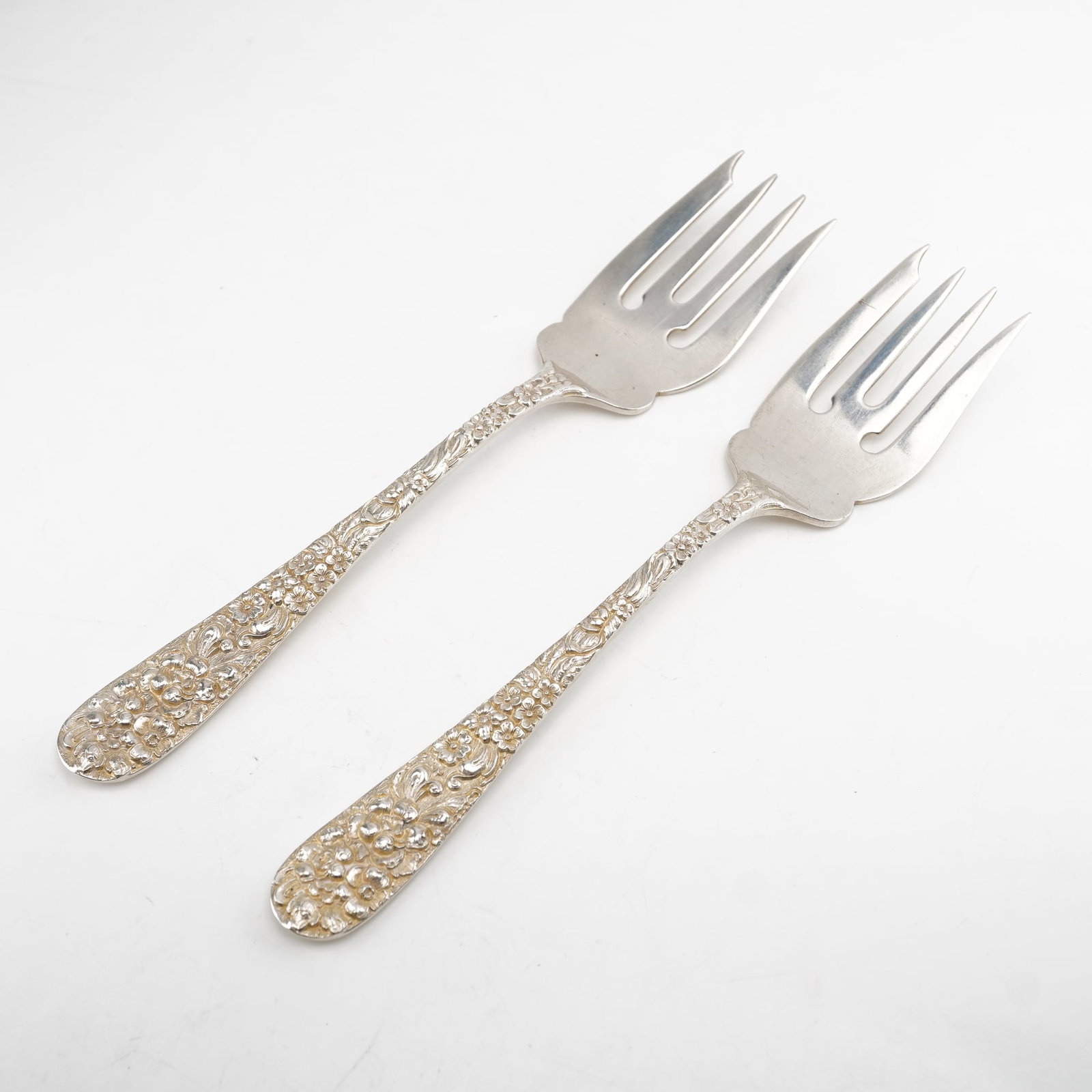 2pc Kirk Stieff Sterling Silver Salad Forks, Stieff Rose: Pair of salad forks in the iconic Stieff Rose design by Kirk Stieff, first introduced in 1892. Each piece showcases a sterling silver handle with richly detailed floral repousse decoration, rendered i