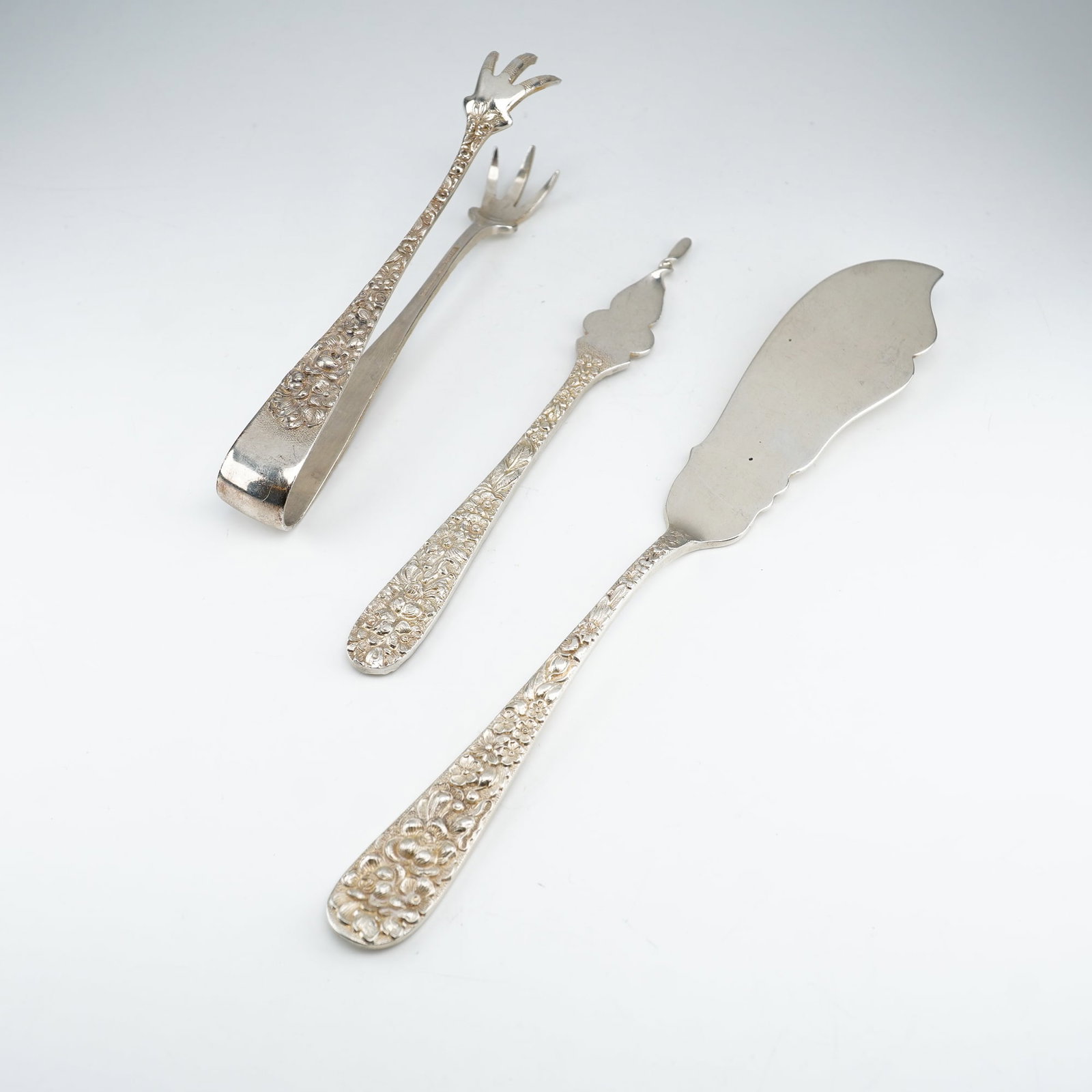 3pc Kirk Stieff Sterling Silver Serving Utensils, Stieff Rose: An assembled group of sterling silver serving pieces in the renowned Stieff Rose pattern by Kirk Stieff, introduced in 1892. Includes a pair of sugar tongs, one-tine butter pick, and flat-handle maste
