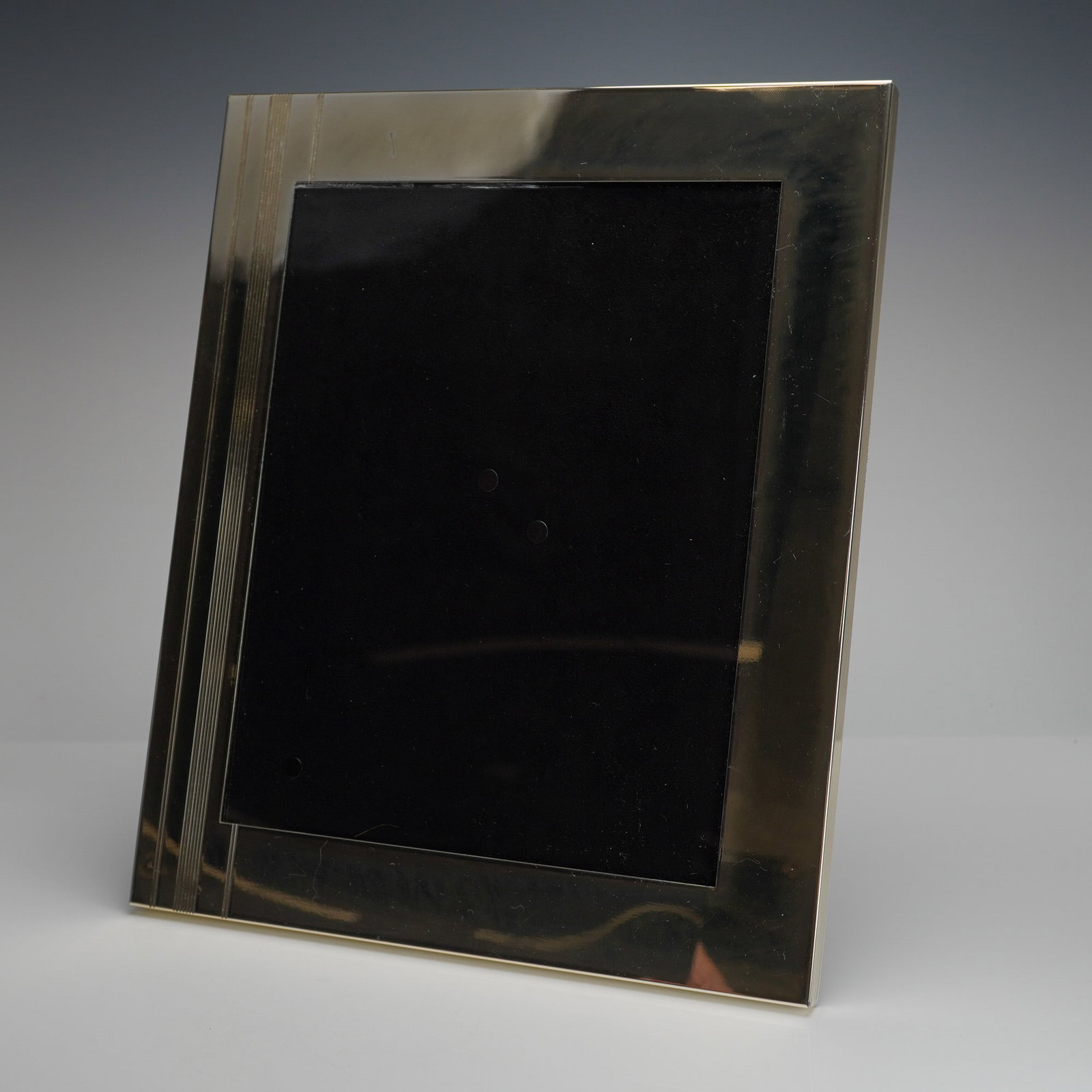 Kate Spade Lenox Art Deco Style Silver Toned Picture Frame: A contemporary picture frame produced by Kate Spade New York for Lenox. The silver-toned metal frame exhibits Art Deco styling, characterized by a wide, polished border accented by a section of