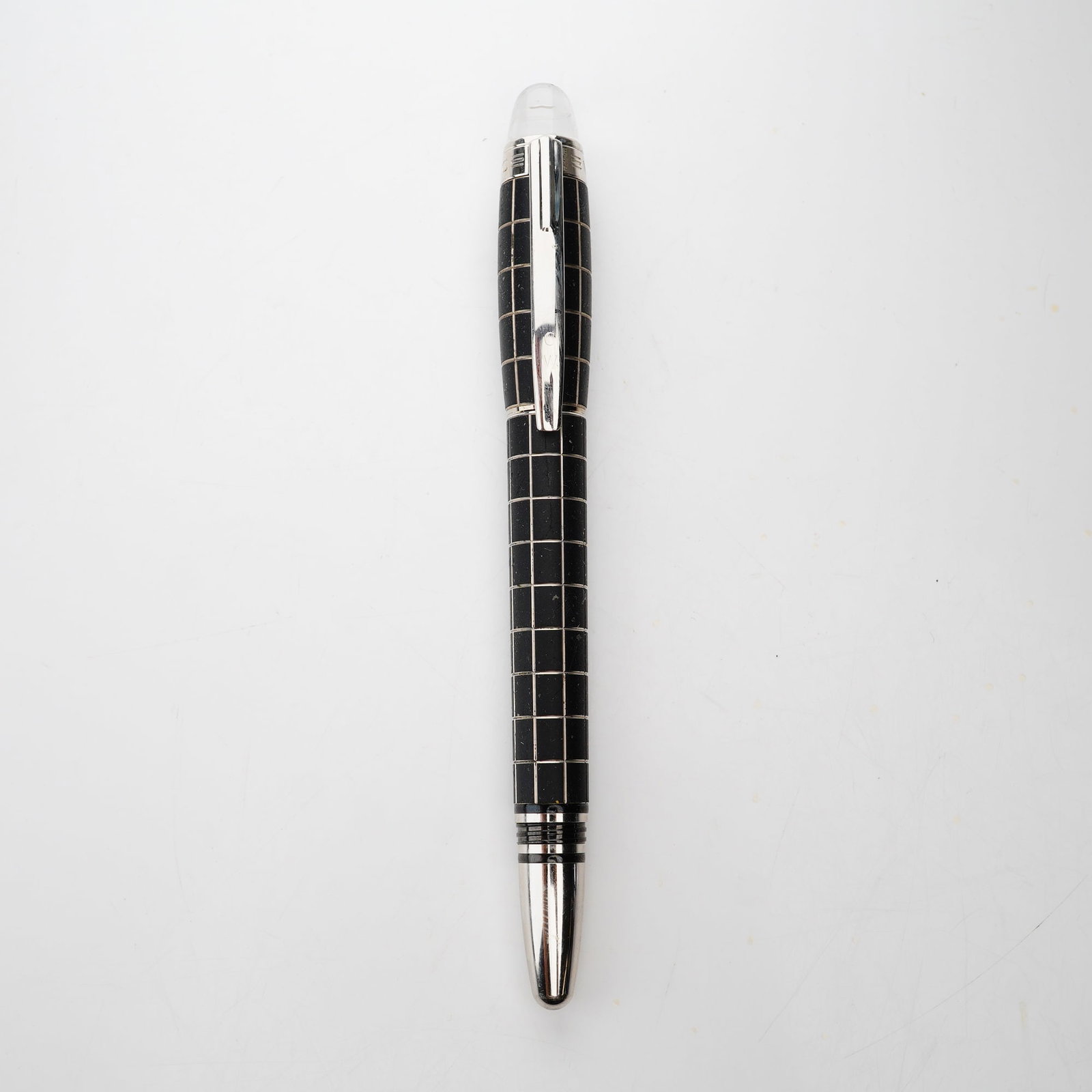 Montblanc StarWalker Rollerball Pen: A Montblanc StarWalker Metal Rubber rollerball pen, also referred to as a Skywalker model. The writing instrument features a black rubberized barrel and cap decorated with a diamond-cut,