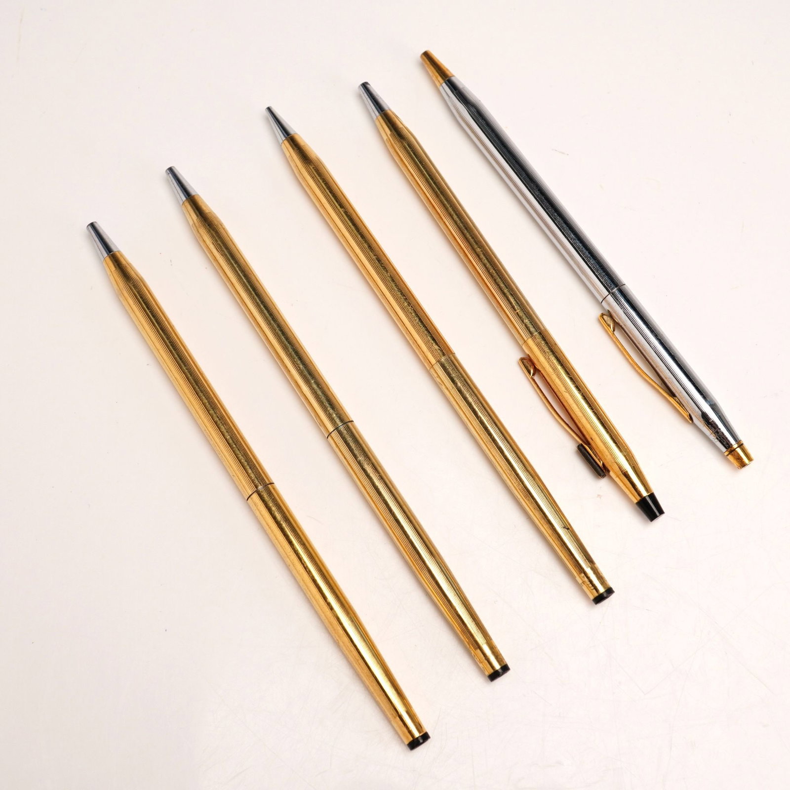 5pc Cross Ballpoint Pens and Mechanical Pencil: Four classic, slim-profile ballpoint pens and one mechanical pencil by maker Cross. These twist-action pens and pencil are a staple for collectors and professionals alike. Includes two highly