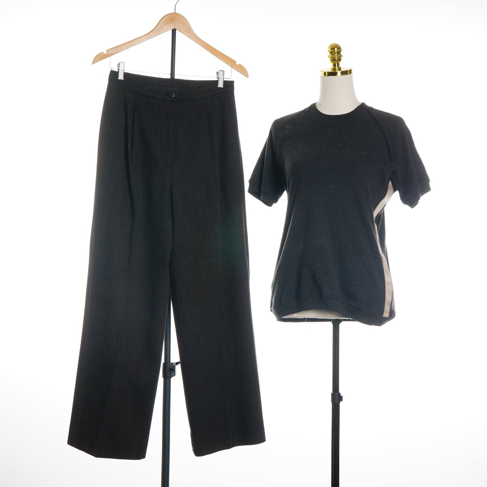 2pc Chanel Charcoal Grey Knit Set: A two-piece ensemble by Chanel consisting of a short-sleeved sweatshirt-style top and coordinating wide-leg trousers in charcoal grey. This set pairs pieces from two distinct collections. The