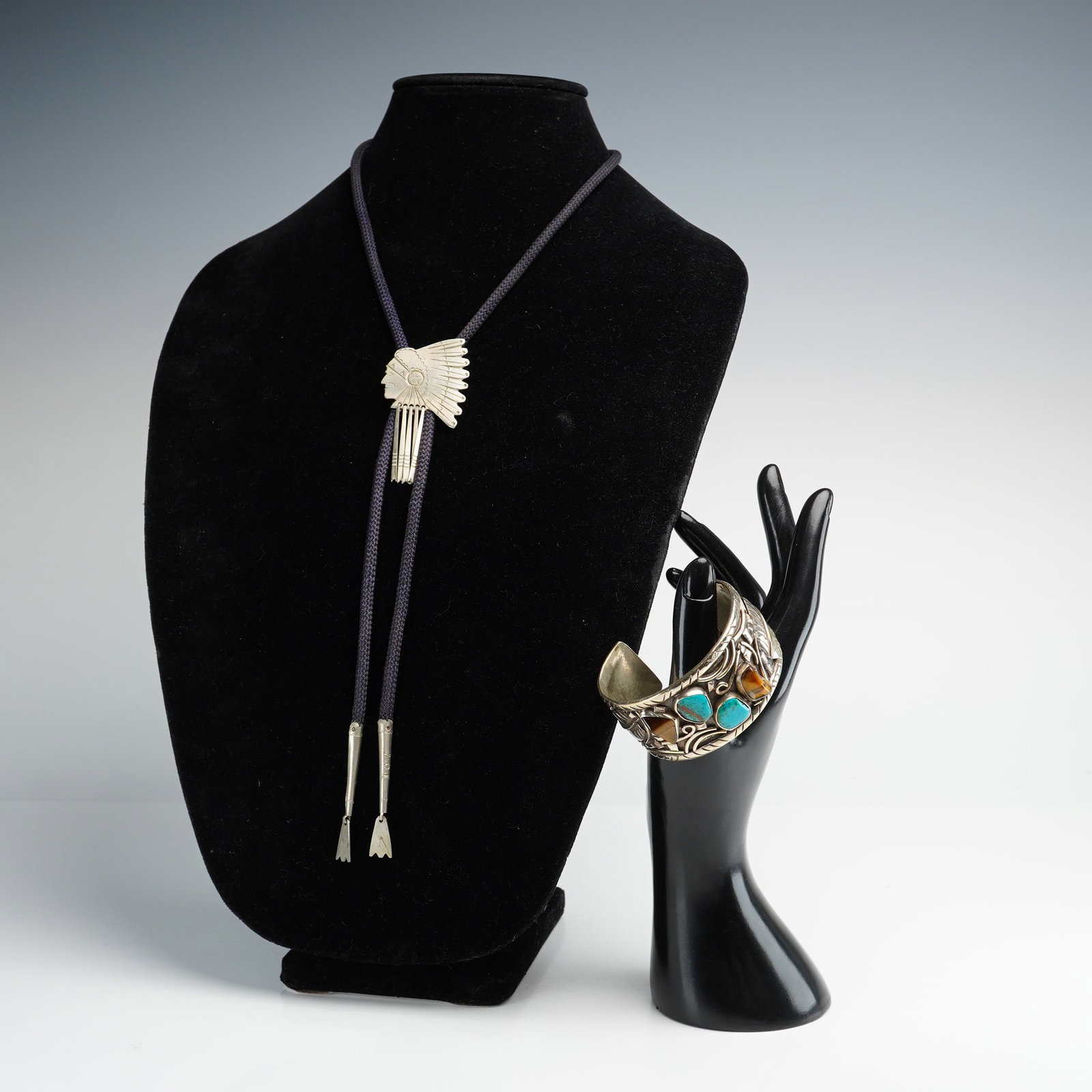 Two Navajo Sterling Silver Cuff Bracelet with Tiger's Eye & Turquoise plus Indian Chief Braided Cord: Southwestern and Native American-style accessories, including a sterling silver cuff bracelet and one braided cord bolo tie. The cuff bracelet features traditional handcrafted styling with a polished 