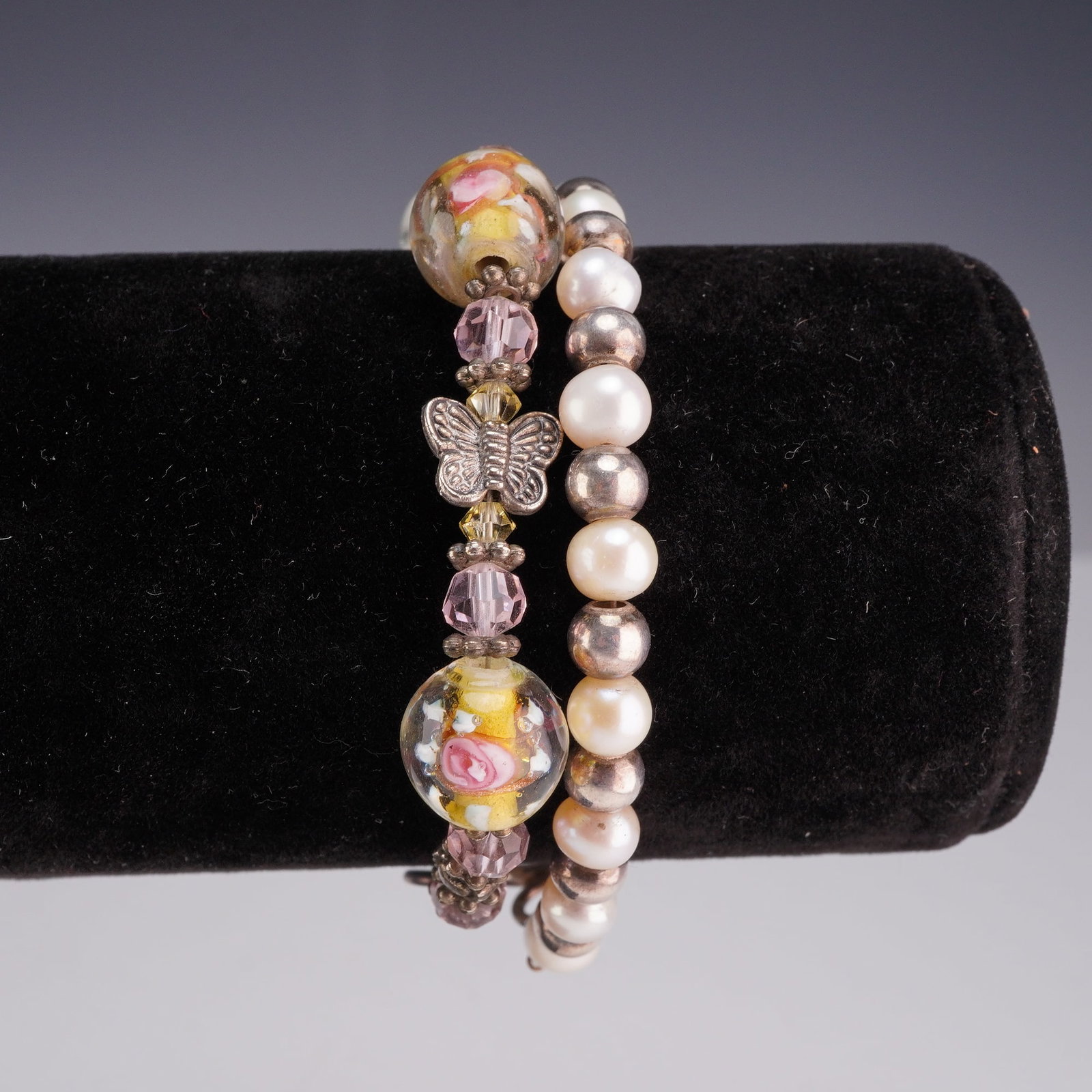 Two Sterling Silver Beaded Bracelets with Lampwork Glass and Cultured Pearls: Two distinct beaded link bracelets featuring sterling silver hardware. The first bracelet is designed with two large, round clear glass lampwork beads containing internal yellow, white, and pink flora