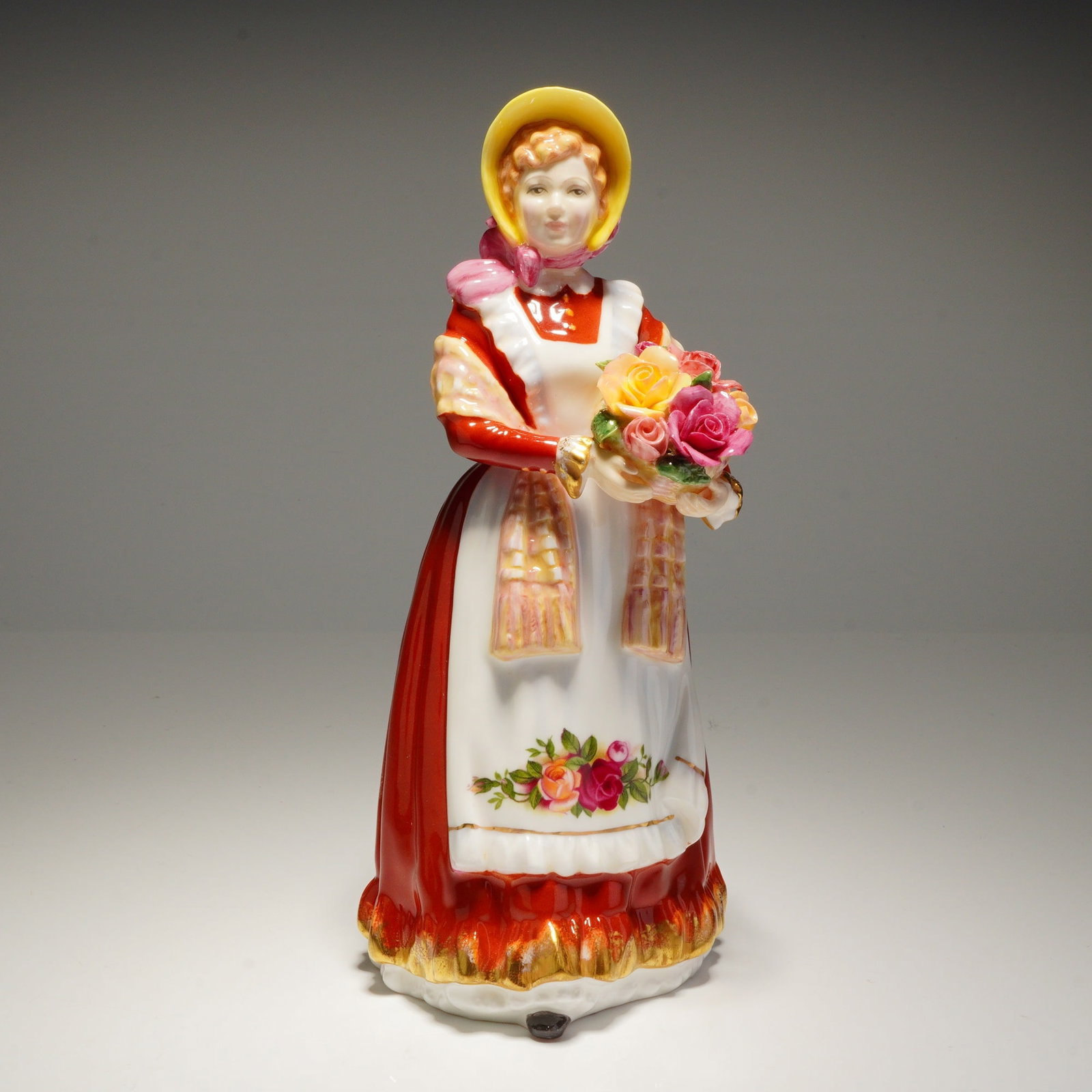 Royal Doulton Figurine Old Country Roses HN 3692: A Royal Doulton Figurine old country roses hn3692 porcelain figurine, HN 3692, painted red, white, and yellow, marked "Modelled by Nada M. Pedley" and dated 1995. Dimensions: 3.50"L x 3.75"W x 8.00"H 