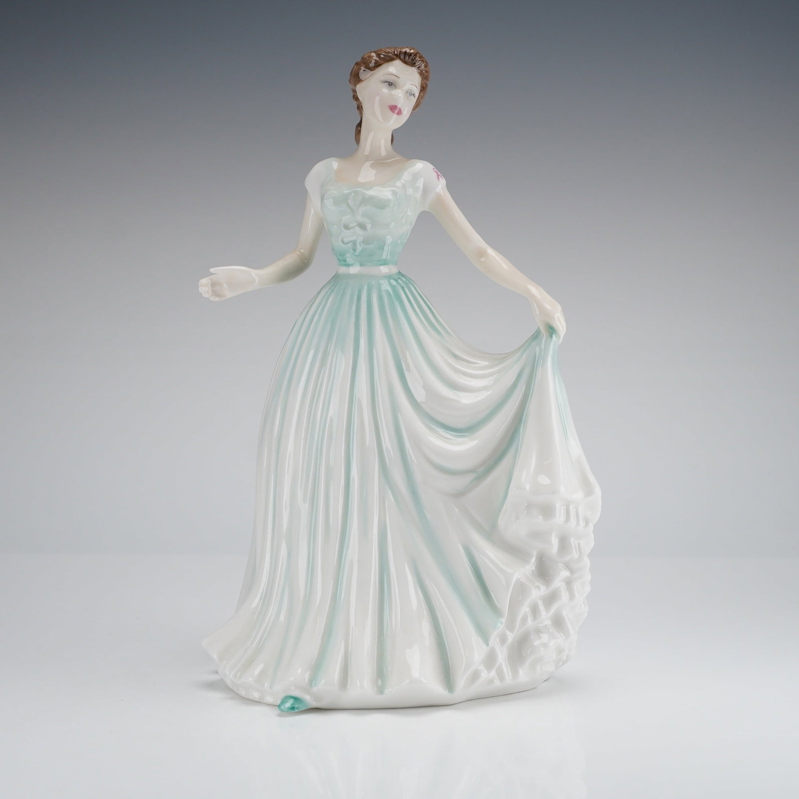 Royal Doulton Figurine, Spring Morning HN 4451: The figure was modelled by Amanda de Paling and dated 2001. It depicts a standing woman in a traditional style, wearing a long, flowing dress glazed primarily in white with pale teal or mint green acc