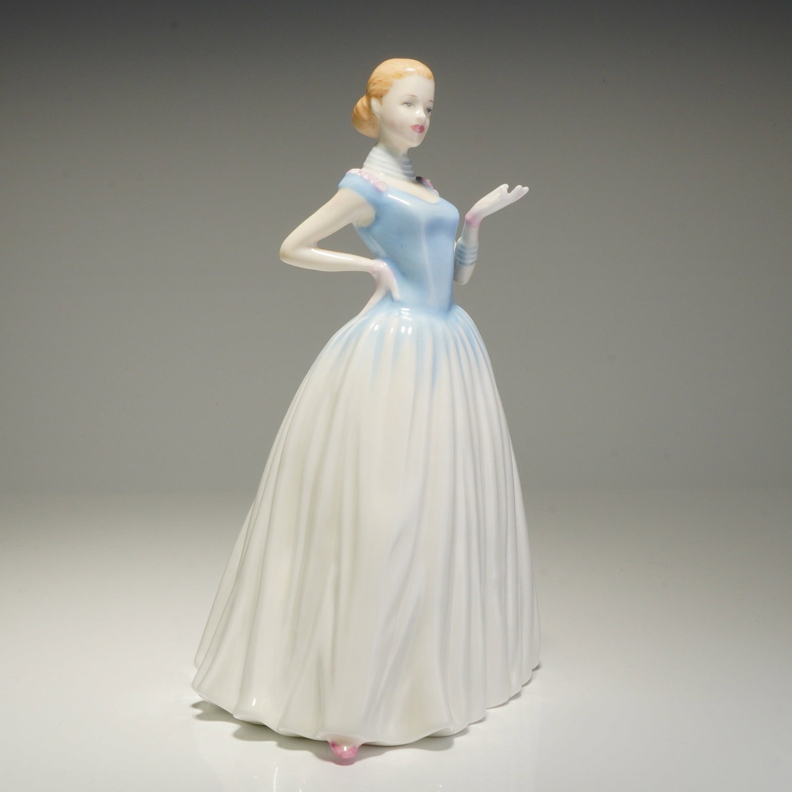 Royal Doulton Happy Birthday 2002 HN4393 Figurine: This Royal Doulton bone china figurine is from the Happy Birthday collection, identified as model HN4393 from the Classics series. Modeled by Nada M. Pedley, the piece is hand-made and hand-decorated 