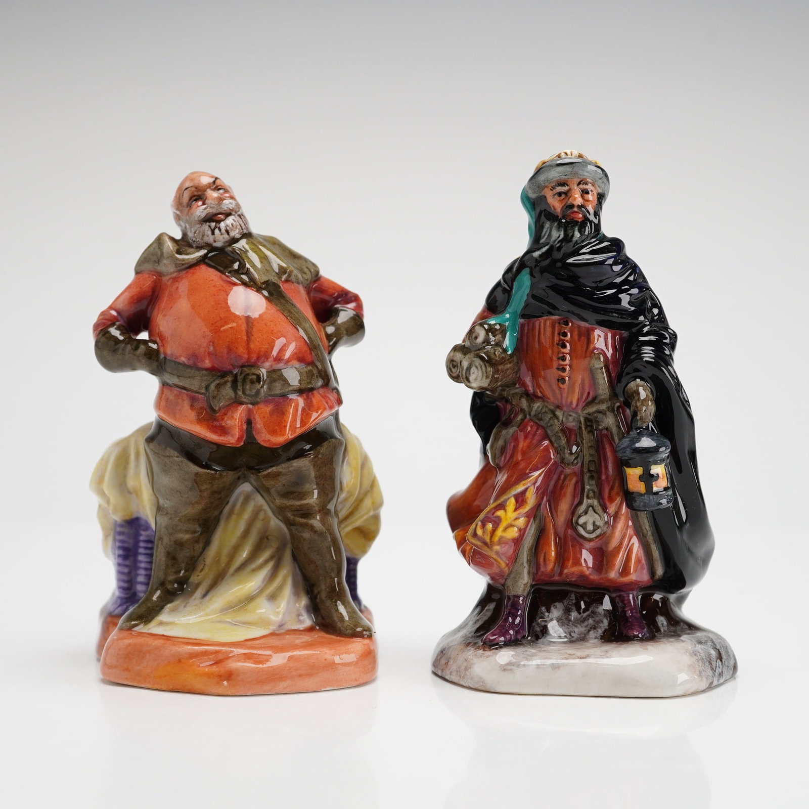 2 Royal Doulton Mini Figurines Falstaff HN3236 & Good King Wenceslas HN3262: The Falstaff figurine, model HN 3236, was designed by Cecil J. Noke and features a 1949 copyright mark. The character is depicted in a seated pose wearing a red tunic and brown breeches. The Good King
