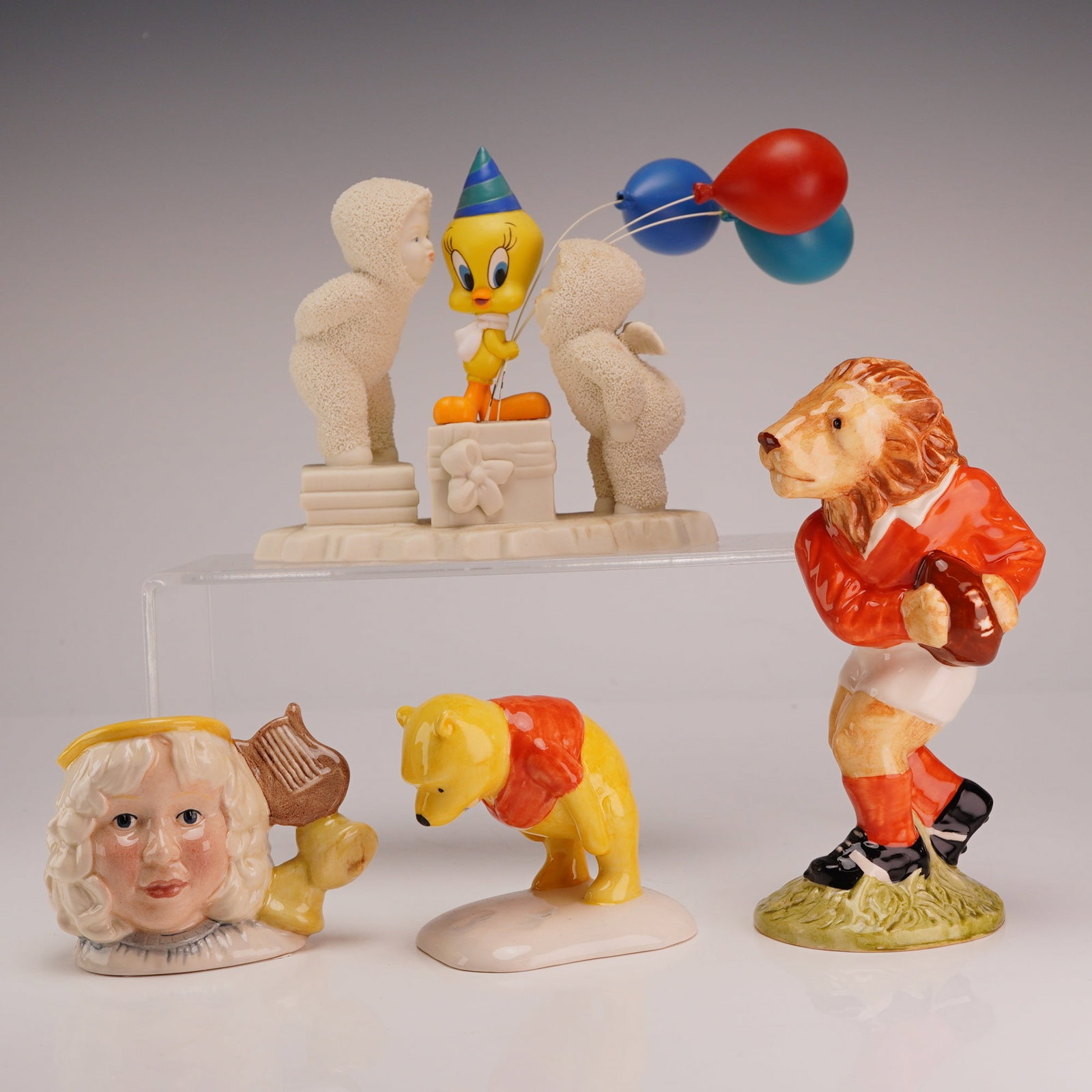4pc Royal Doulton, Beswick and Dept 56 Figurines including Angel Character Jug D7051, Winnie the: This collection of four ceramic figurines features a Department 56 Snowbabies Guest Collection piece titled A Kiss for You and 2000 Too, depicting two textured bisque figures alongside the Warner Bros