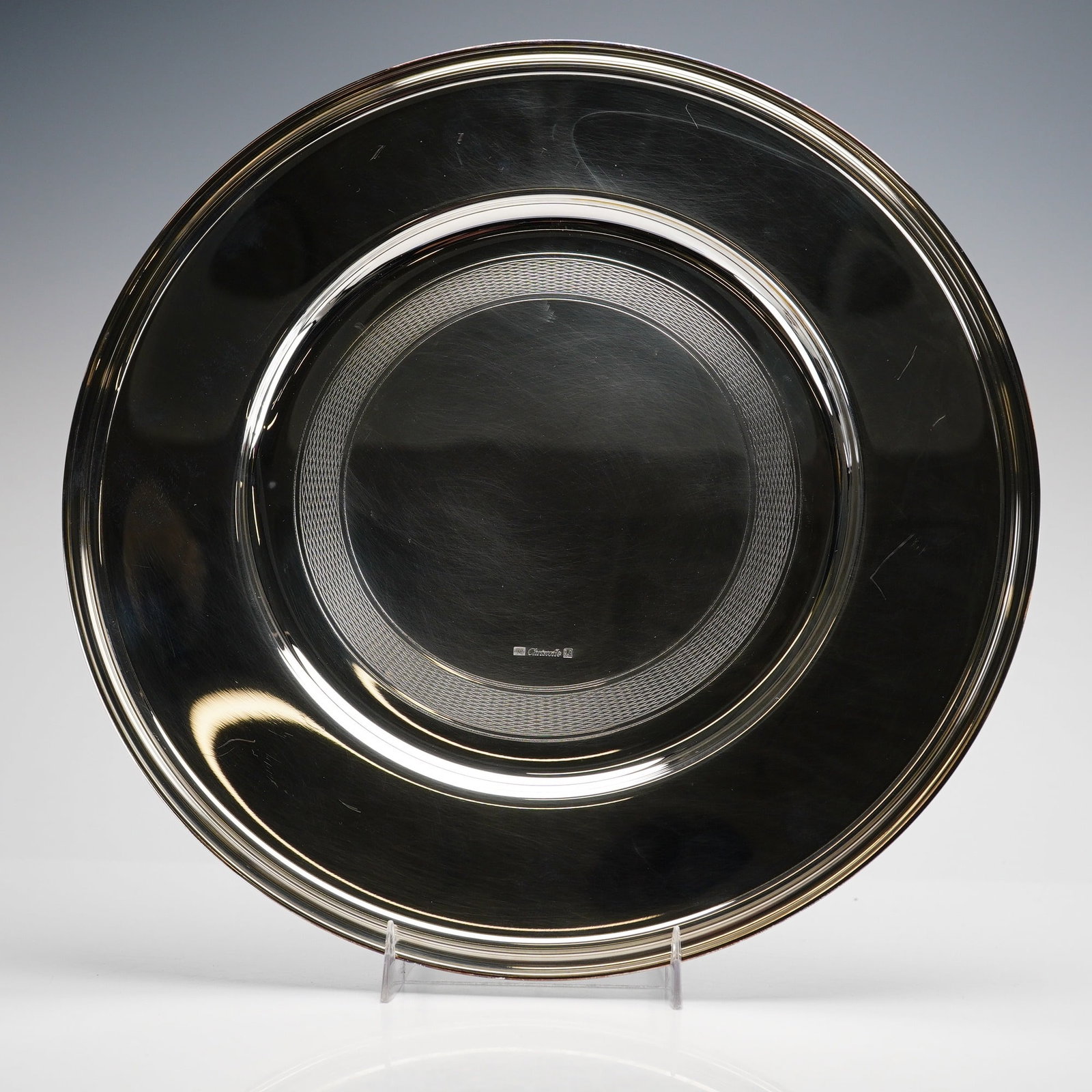Christofle Albi Pattern Silver-Plated Service Plate: A silver-plated service plate or underplate in the Albi pattern by Christofle, Paris. The circular platter is characterized by a wide, polished rim and a central well bordered by a decorative engine-t