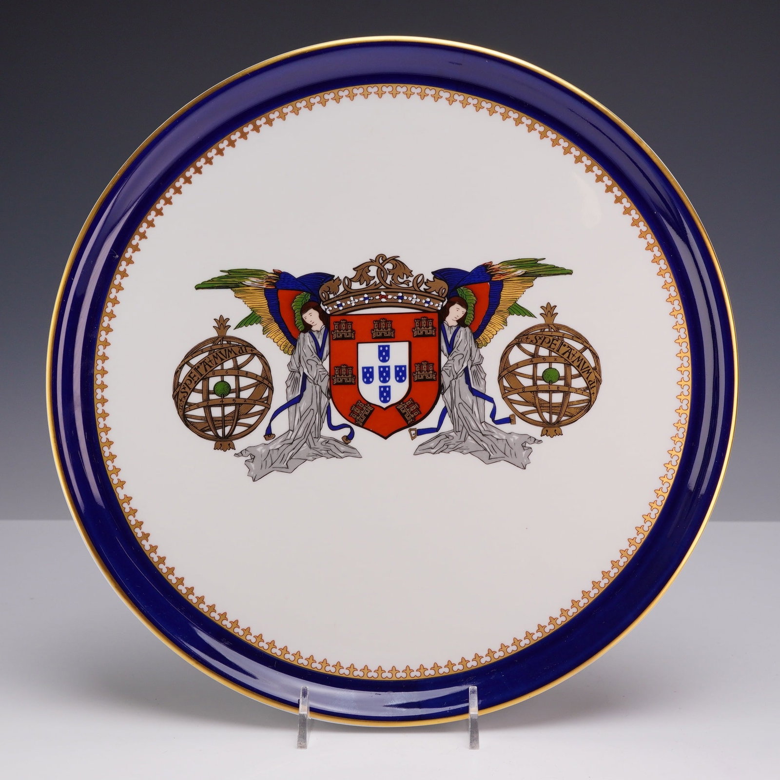 Portuguese Porart Porcelain Plate with Coat of Arms, D. Manuel I Pattern: This circular porcelain plate was manufactured by Porart in Portugal as part of the Companhia das Indias series. The central decoration features a polychrome coat of arms of Portugal supported by two 