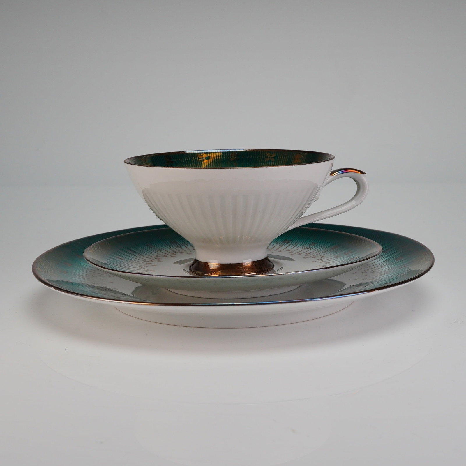 Bareuther Waldsassen Bavaria Trio Tea Set, Emerald Gold: This trio set is decorated in a striking Mid-Century Modern style. The white porcelain body is adorned with a lustrous, iridescent emerald, green band overlaid with an intricate radial gold starburst 