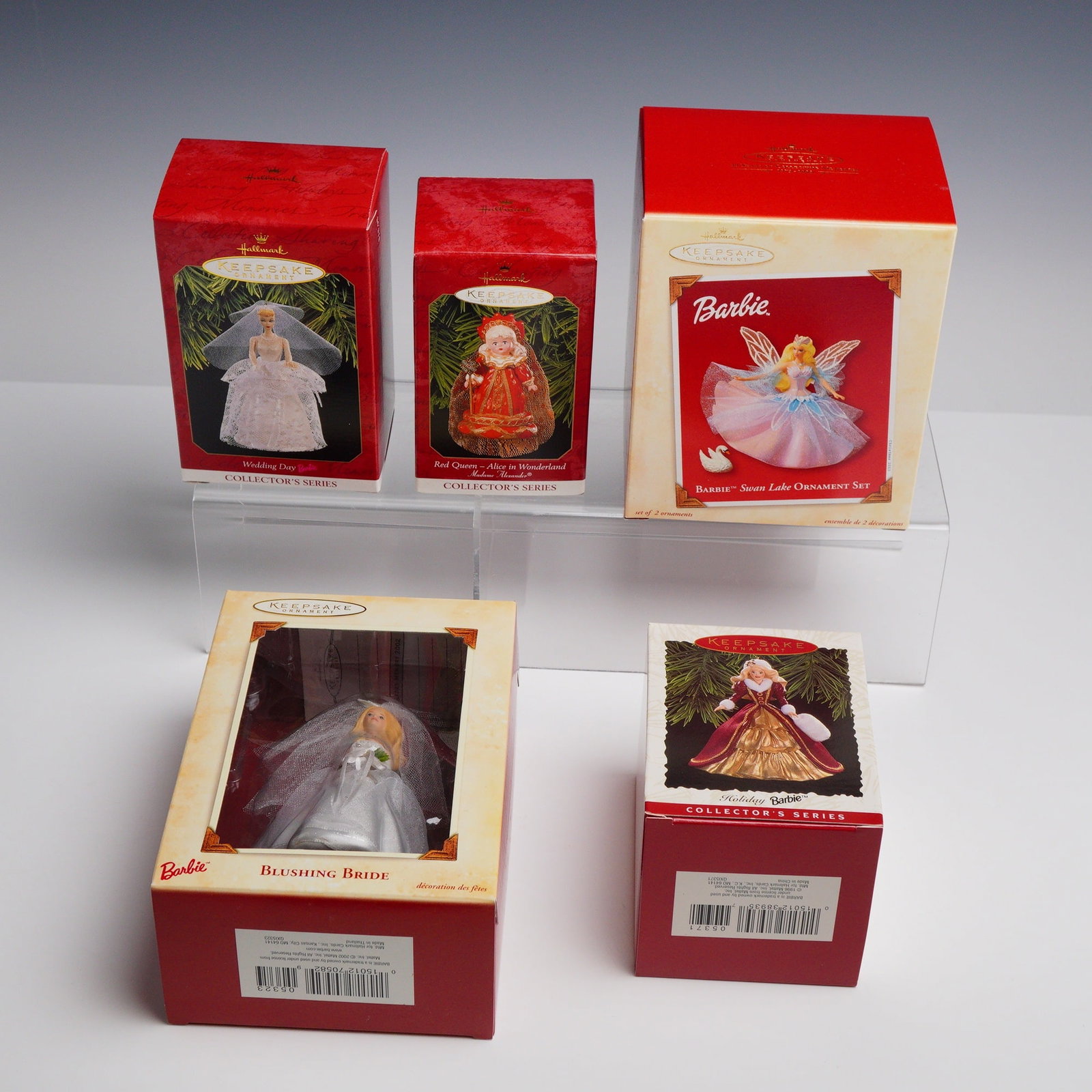 5pc Hallmark Keepsake Barbie and Madame Alexander Ornaments: This lot includes five Hallmark Keepsake Ornaments featuring Barbie and Madame Alexander designs, dating from 1996 to 2003. Each ornament is housed in its original manufacturer packaging. The collecti