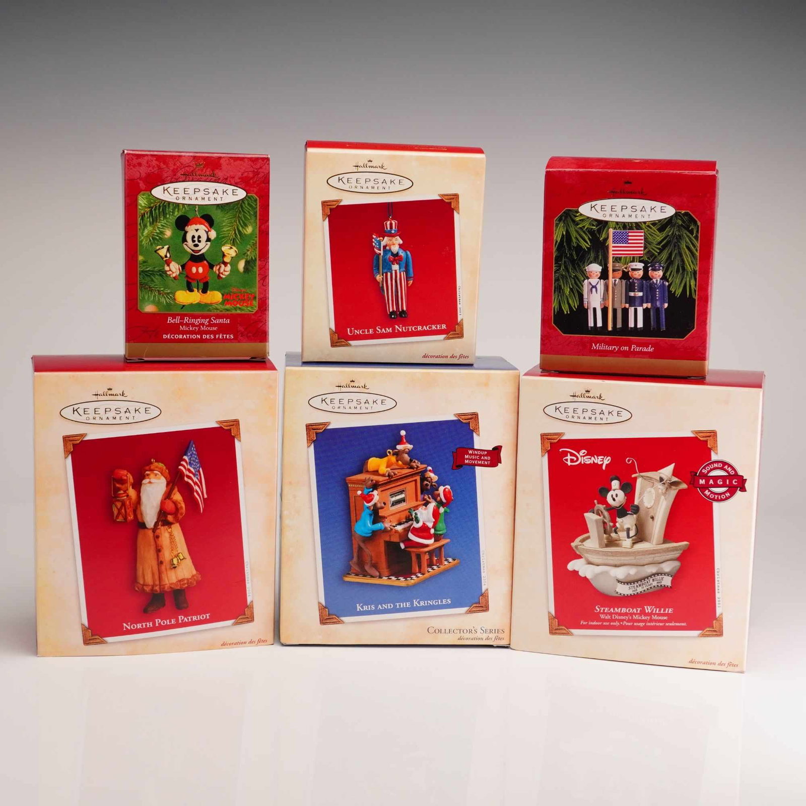 6 Hallmark Keepsake Ornaments Featuring Patriotic and Disney Characters: A collection of 6 Hallmark Keepsake Ornaments in their original illustrated cardboard packaging. The assortment includes a variety of themes and specialized features. Disney entries consist of Steambo