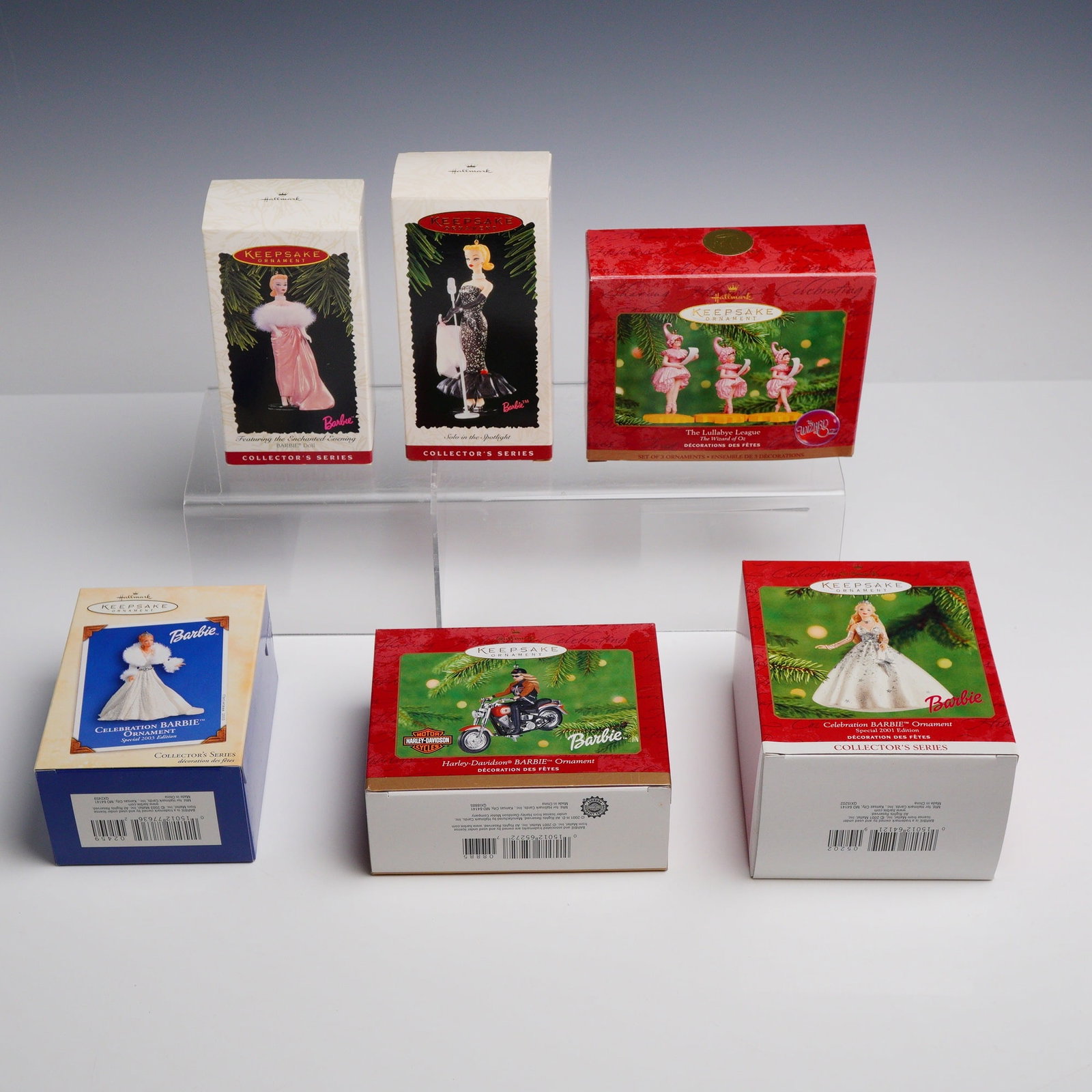 6pc Hallmark Keepsake Ornaments: This collection consists of six Hallmark Keepsake Ornaments, each housed in its original individual retail packaging. The set primarily features Barbie doll themes, along with a set from The Wizard of