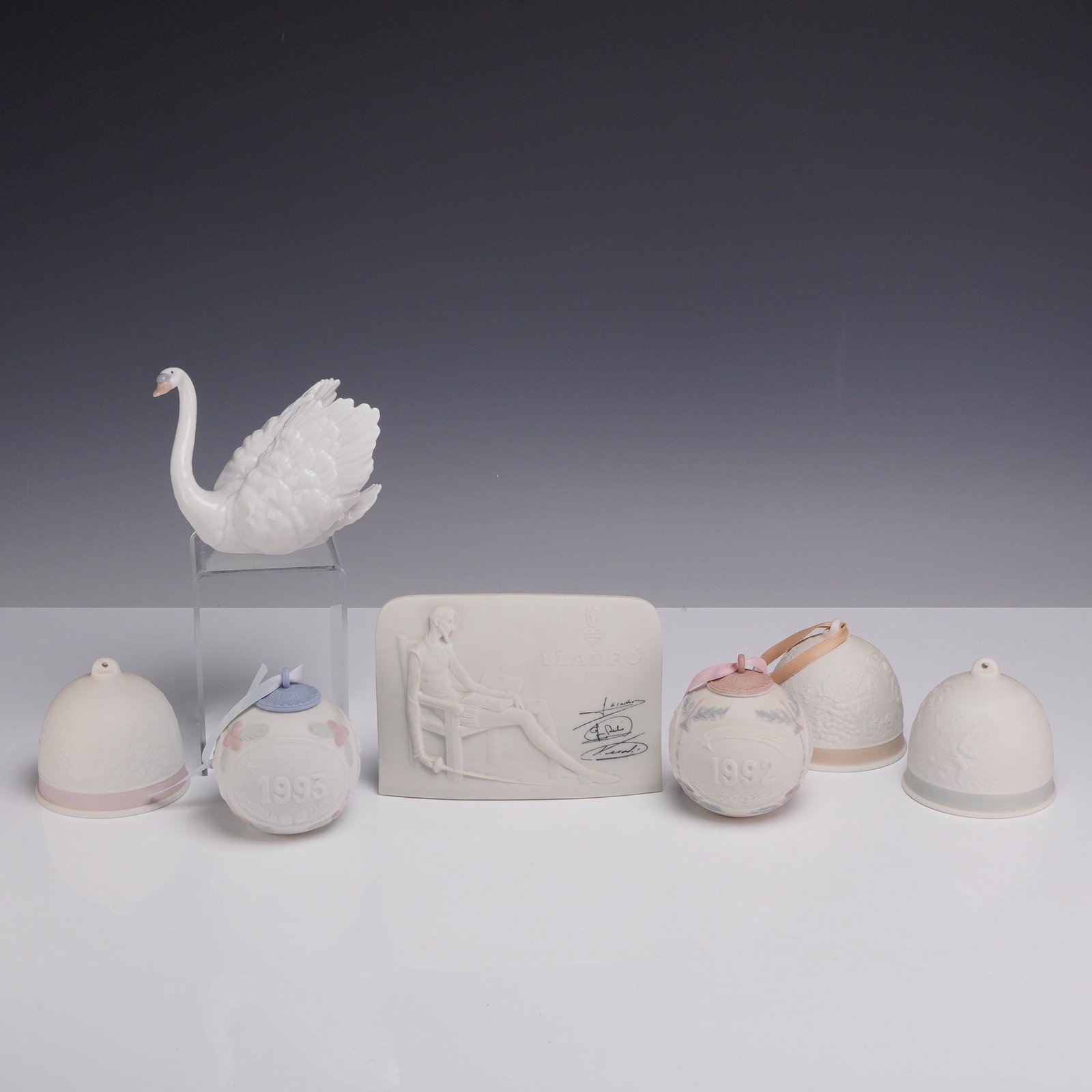 A Collection of Seven Lladro Porcelain Items Including Swan Figurine and Commemorative Ornaments (1 of 3)