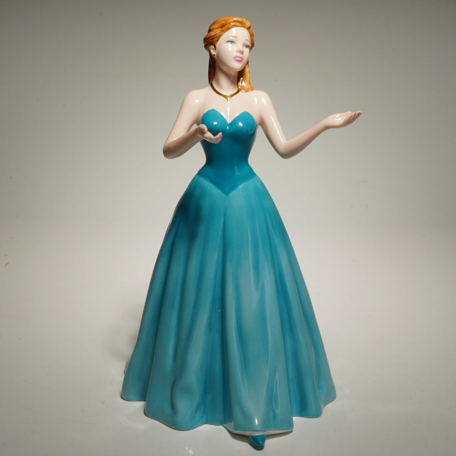 Royal Doulton Pretty Ladies Porcelain Figurine, Loyal Friend: Royal Doulton fine bone china figurine Loyal Friend, model HN4736, issued in 2004 as part of the Pretty Ladies series. The figure depicts a standing young woman wearing a strapless blue gown with flow