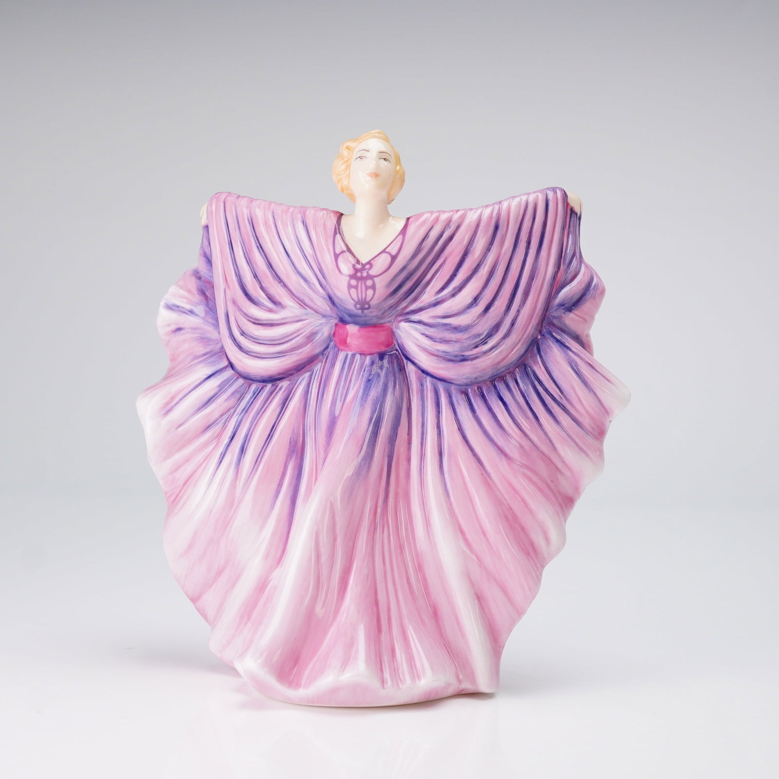 Royal Doulton Limited Edition Porcelain Figurine, Isadora HN5655: A Royal Doulton figurine, titled Isadora (HN 5655), hand-decorated bone China that depicts a female dancer in a dramatic, sweeping pose, part of the HN Icons series. The figure, based on dancer Isador