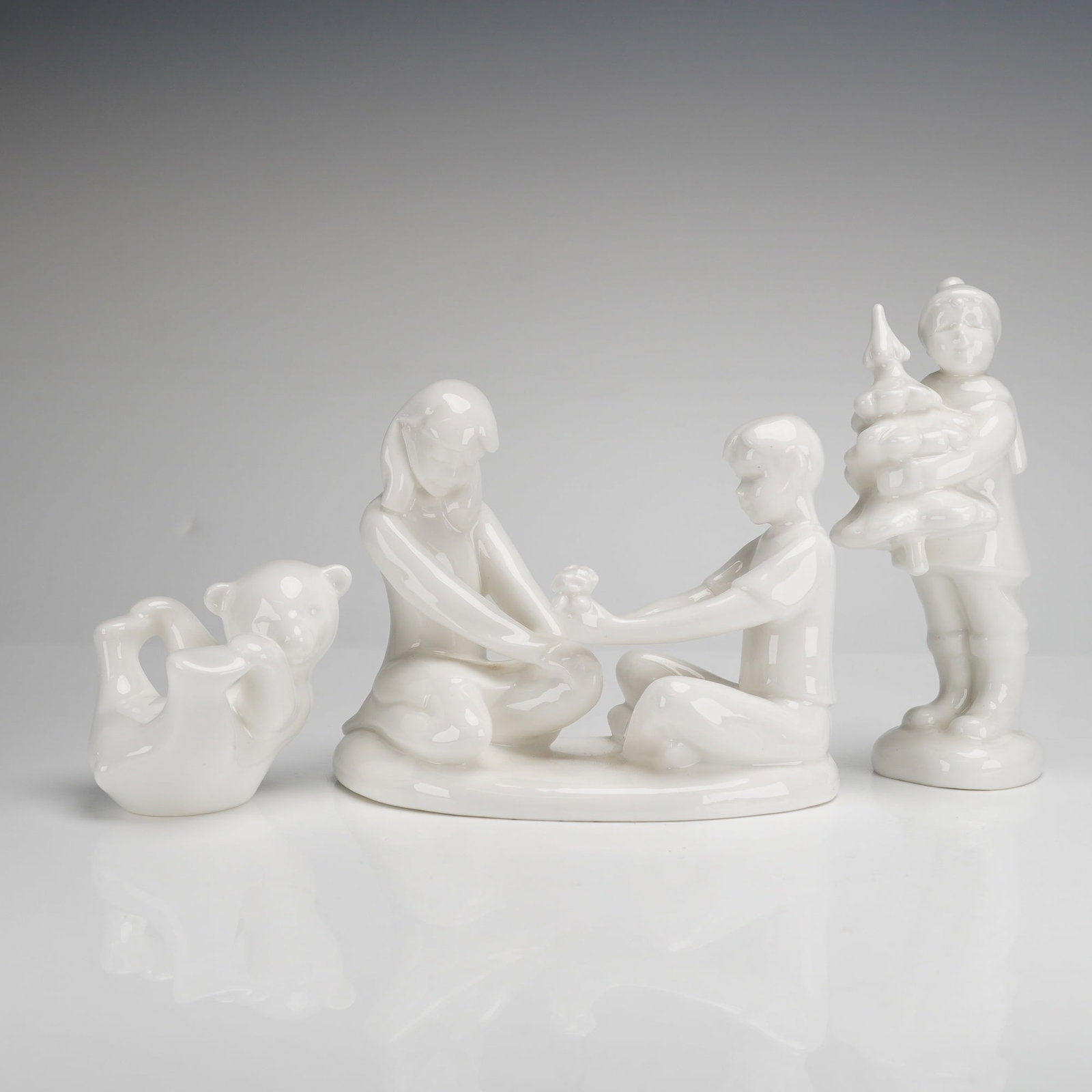 Three Royal Doulton and Coalport Figurines Gift of Friendship Christmas Dreams: A trio of white glazed bone china figurines featuring two works from the Royal Doulton Classics Images series and one Coalport figure. The group includes Gift of Friendship (HN 4446), the 2003 Figure 