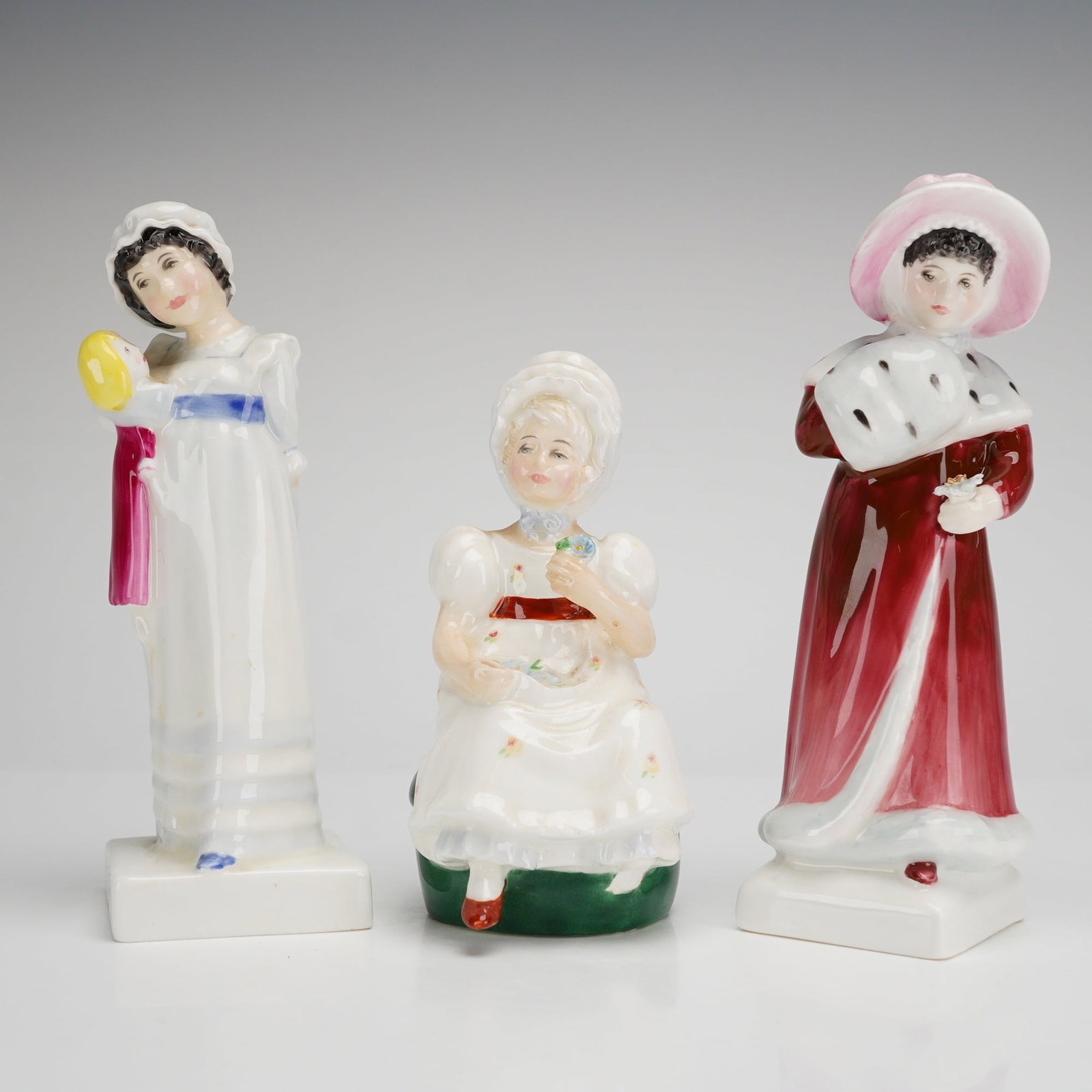 Three Royal Doulton Bone China Figurines, Kathy (HN2346), Sophie (HN2833), and Amy (HN2958): This 3pc collection of Royal Doulton bone china figurines is from the Kate Greenaway Collection and includes the models Kathy (HN2346), Sophie (HN2833), and Amy (HN2958). Each figurine is finished wit