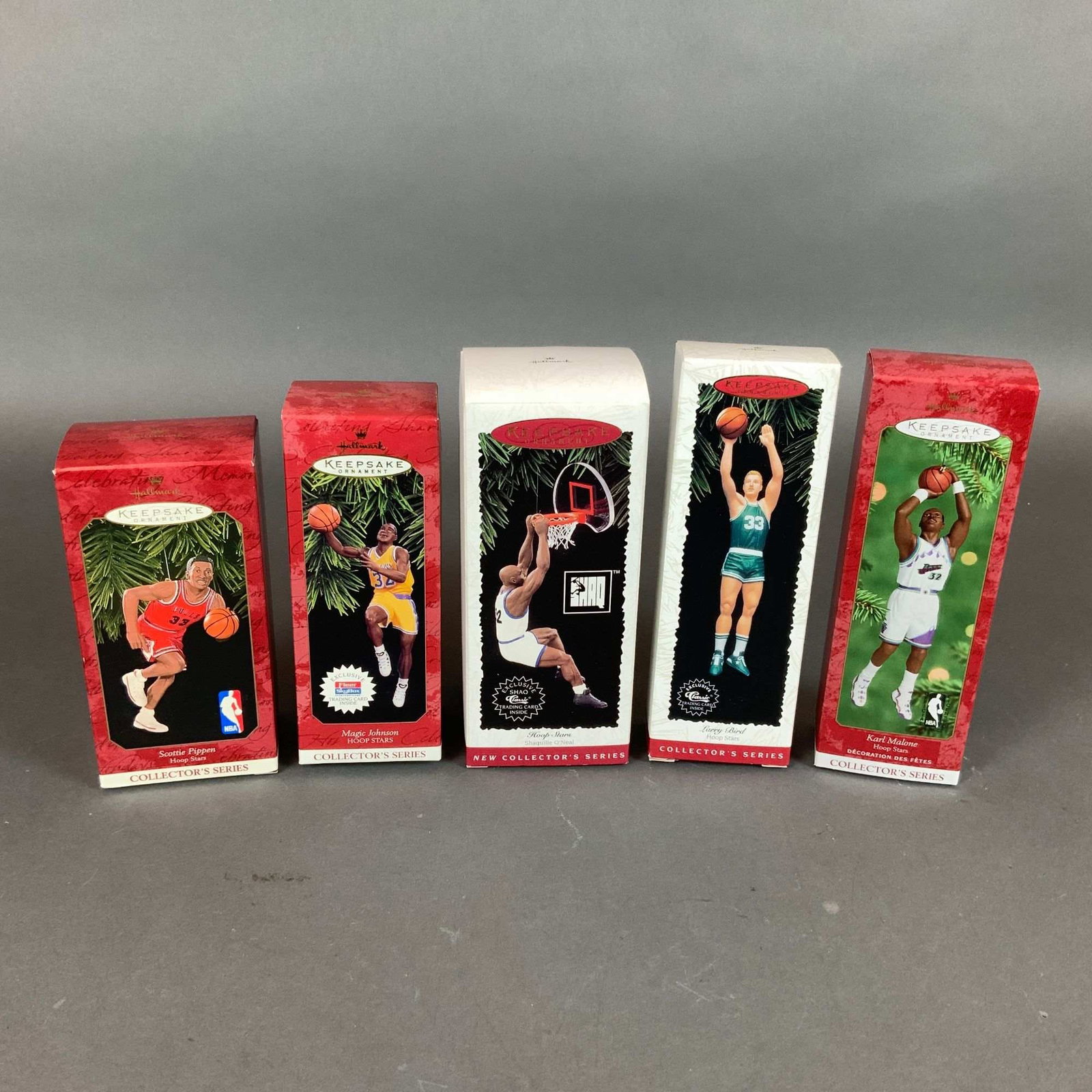 Five Hallmark Keepsake Hoop Stars NBA Basketball Ornaments in Original Packaging: A set of five Hallmark Keepsake Hoop Stars collector's series ornaments featuring prominent NBA players. The collection consists of handcrafted ornaments representing Shaquille O'Neal (1995, First in 