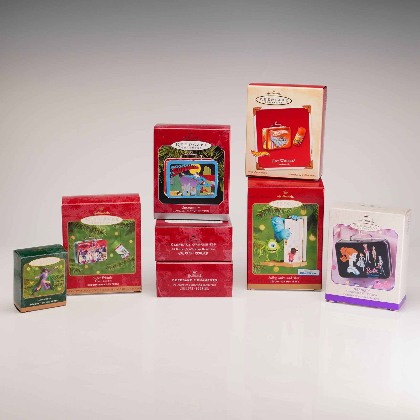 Eight Hallmark Keepsake Ornaments Characters and Superheroes: A collection of eight Hallmark Keepsake Ornaments produced by Hallmark Cards, Inc., featuring various pop culture characters and superhero themes. The lot includes several lunchbox-style designs and