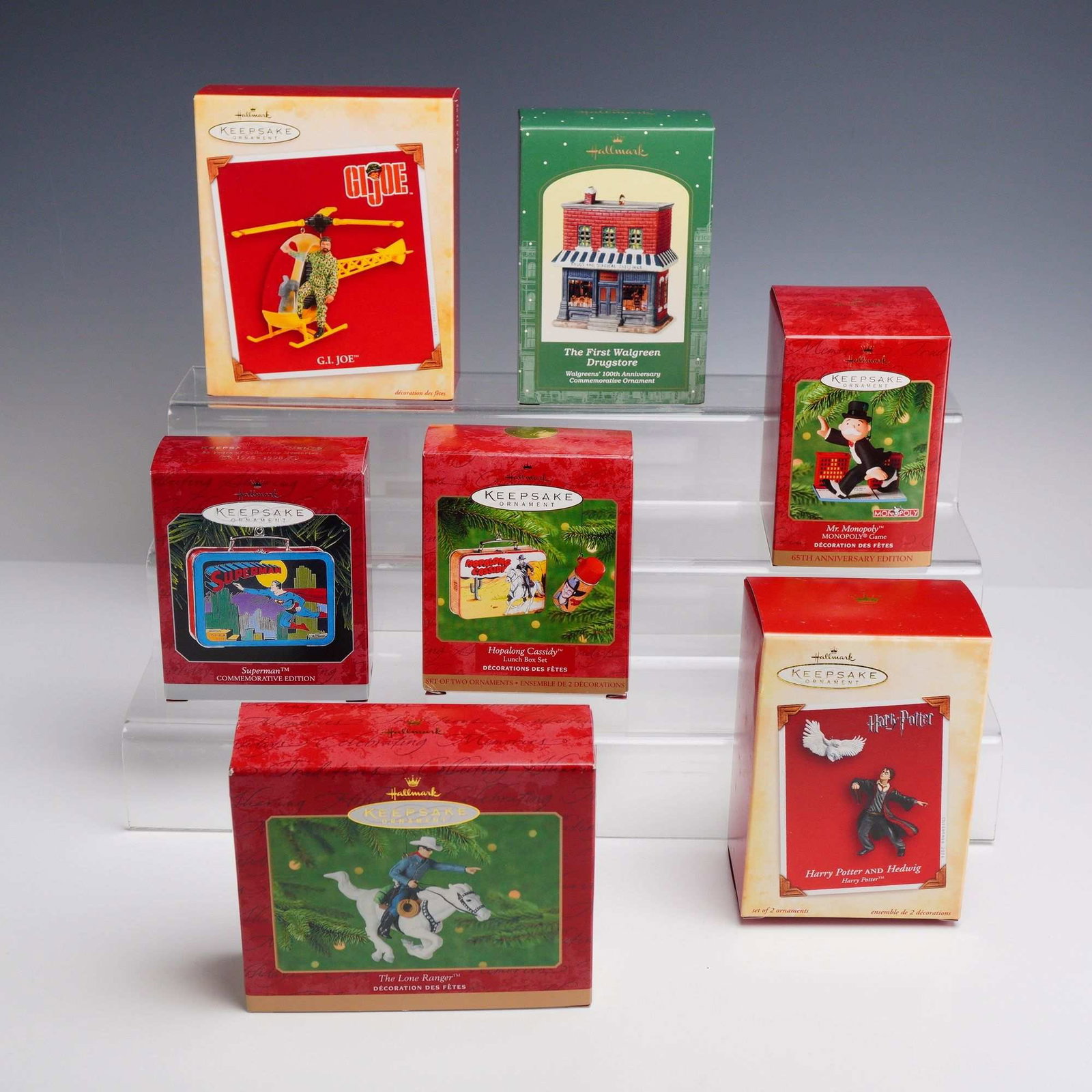 7pc Hallmark Keepsake Ornaments: A collection of 7 Hallmark Keepsake ornaments in their original retail packaging, featuring various pop culture and historical themes. This assortment includes a 2004 G.I. Joe ornament featuring a