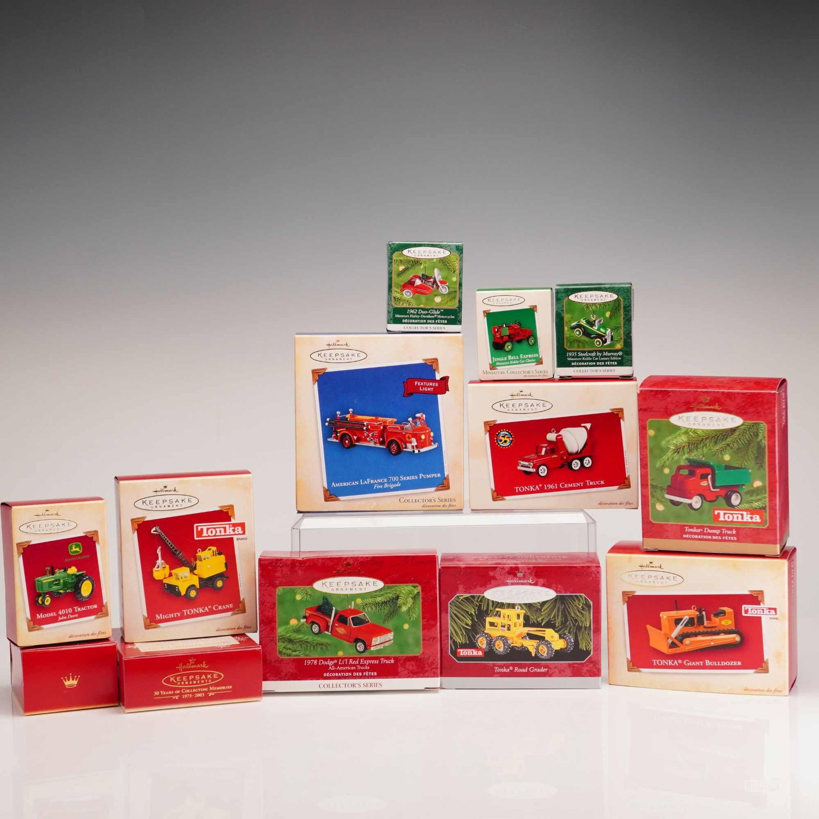 13pc Hallmark Keepsake Miniature Vehicle Christmas Ornaments: This group consists of 13 Hallmark Keepsake Ornaments produced by Hallmark Cards, Inc., primarily featuring miniature vehicles from various collector series. The collection includes several models fro