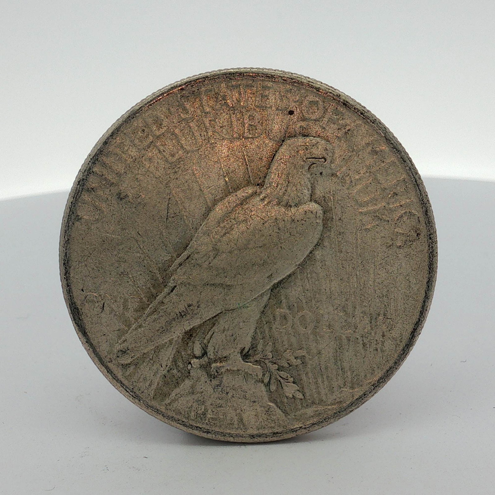 1925 US $1 Peace Silver Dollar: 1925 US $1 Peace silver dollar struck at the Philadelphia Mint. Composition is 90% silver and 10% copper. The coin features the Liberty Head obverse and the Peace dollar reverse design. Dimensions: 1.