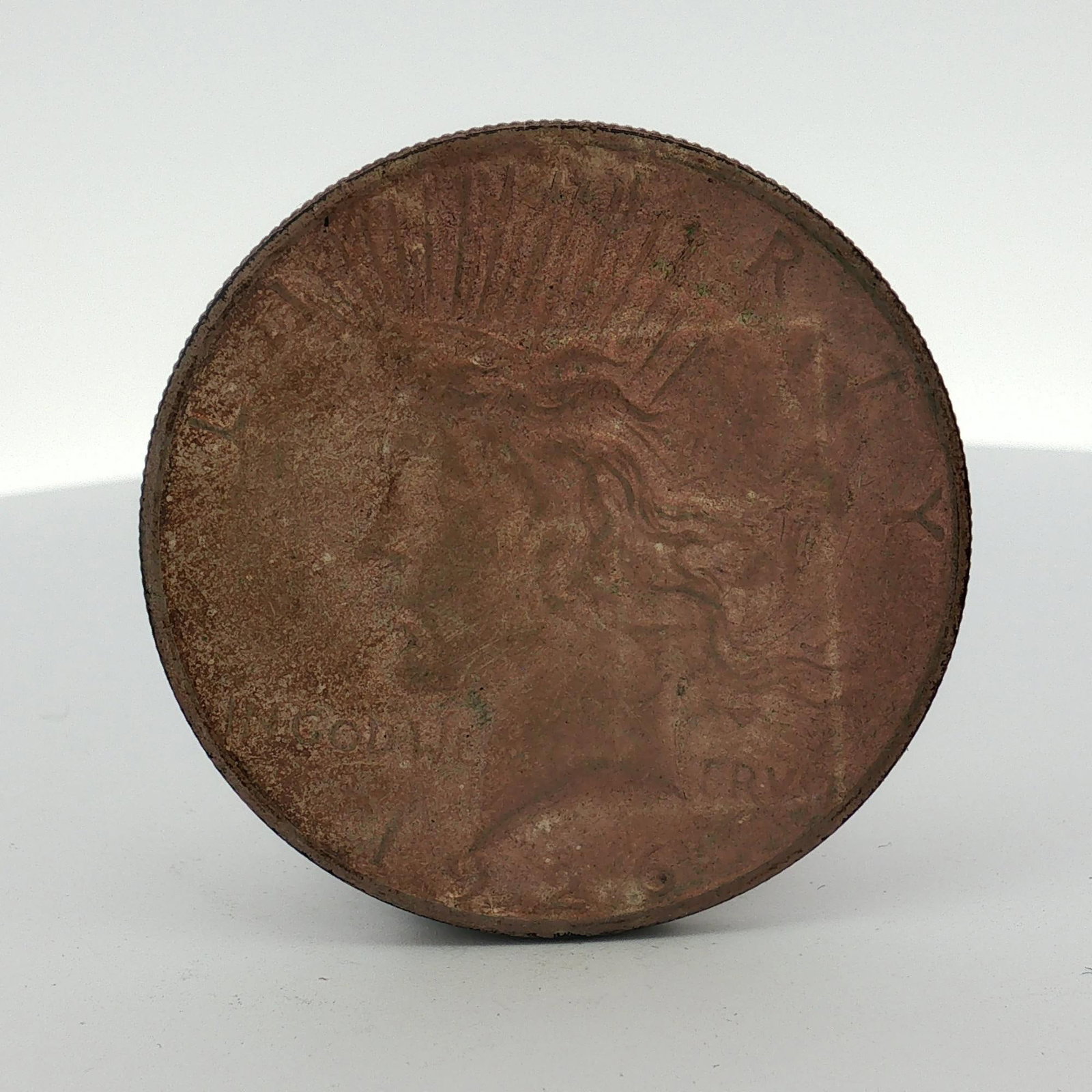 1926-S US Peace Silver Dollar: This US Peace silver dollar features the standard design by Anthony de Francisci. The obverse depicts Liberty with a radiate crown, and the reverse shows an eagle perched on a rock. The coin is