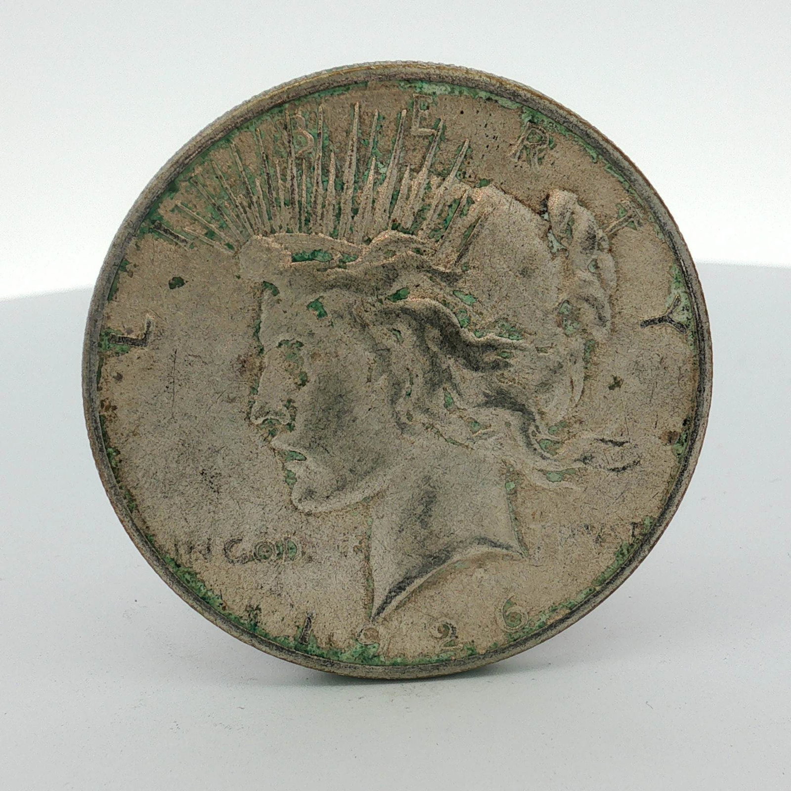 1926-S US Peace Silver Dollar: This is a US Peace silver dollar struck at the San Francisco Mint in 1926. The "S" mint mark is located on the reverse. The coin is composed of 90% silver and 10% copper. It features the Peace Dollar