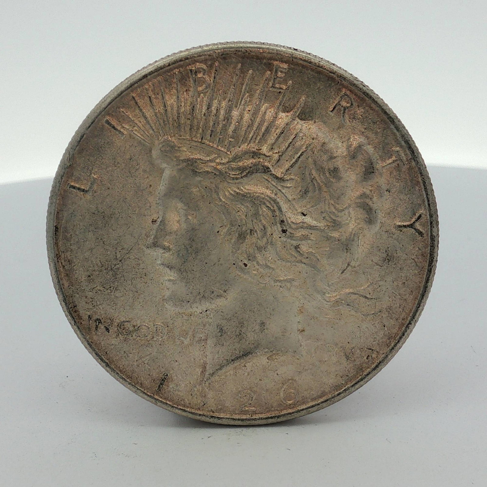 1926-S US Silver Peace Dollar: This US Peace silver dollar was struck in 1926 at the San Francisco Mint, as indicated by the small "S" mint mark on the reverse. The coin features the Peace dollar obverse and reverse designs. It is 