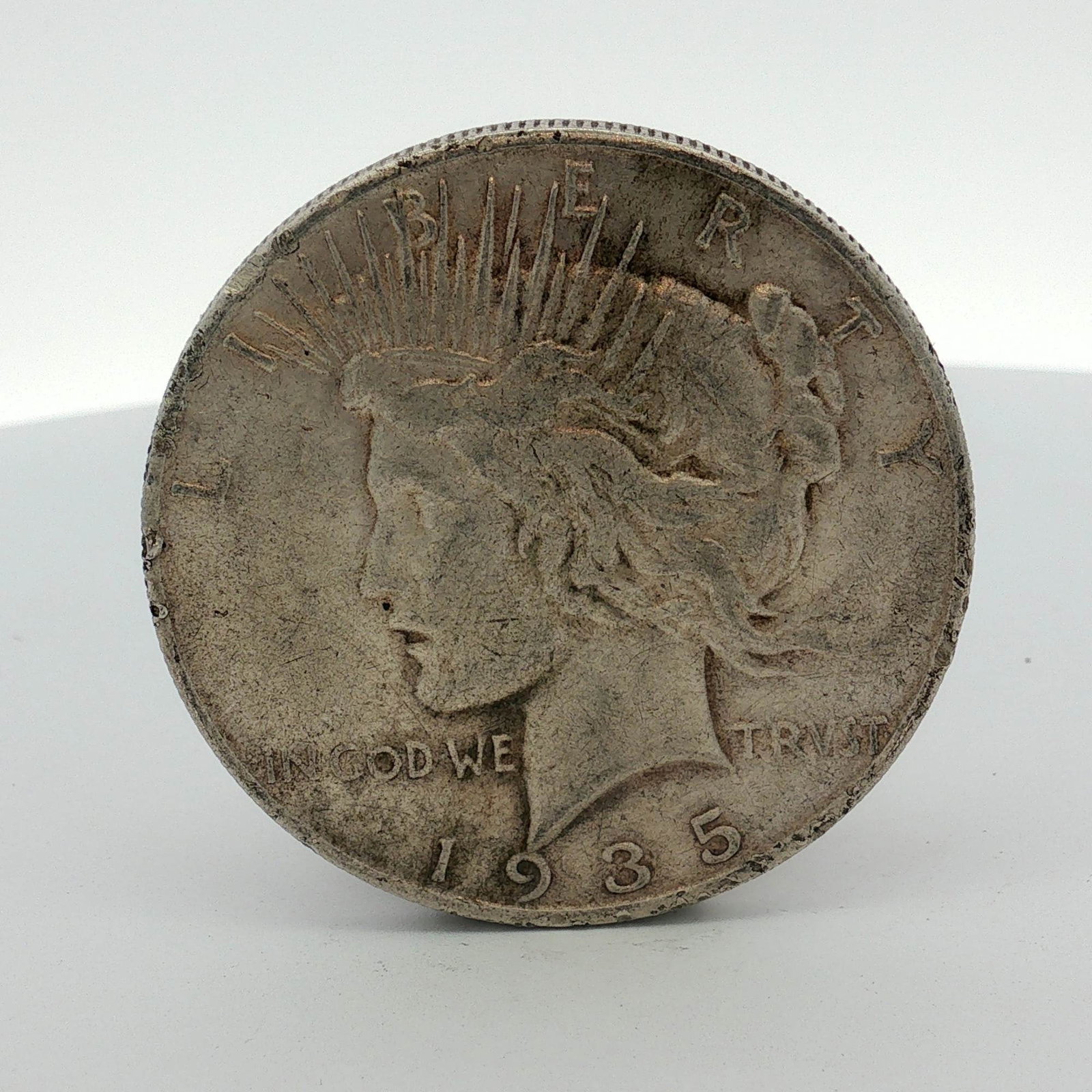 1935-S US Peace Silver Dollar: 1935-S US Peace silver dollar. This coin is composed of 90% silver and was struck at the San Francisco Mint, as indicated by the S mint mark located on the reverse. The obverse features the Peace