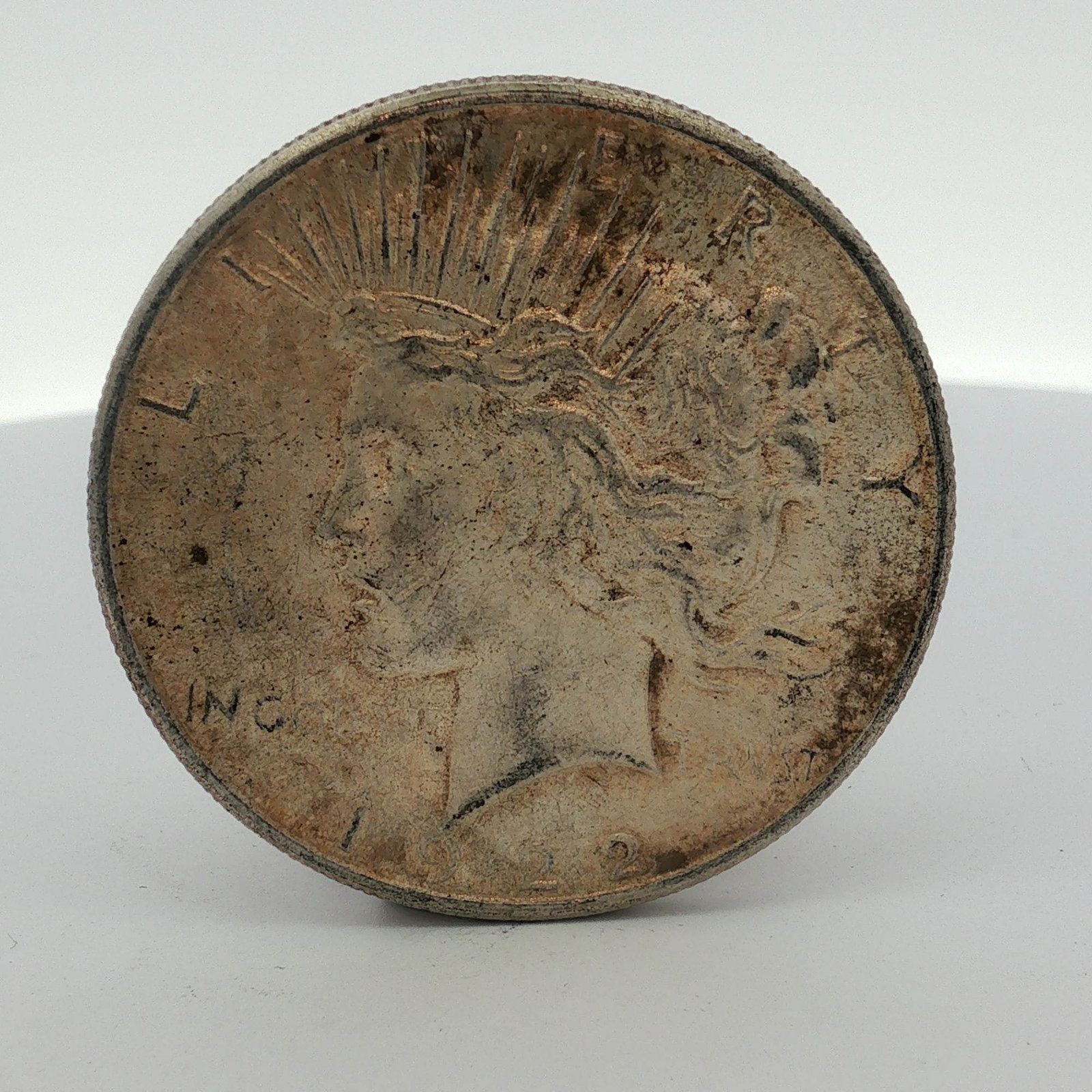 US 1922-S Peace Silver Dollar: One US 1922-S Peace silver dollar struck at the San Francisco Mint. This coin is composed of 90 percent silver and 10 percent copper with a fineness of .900. The obverse features the Peace dollar desi