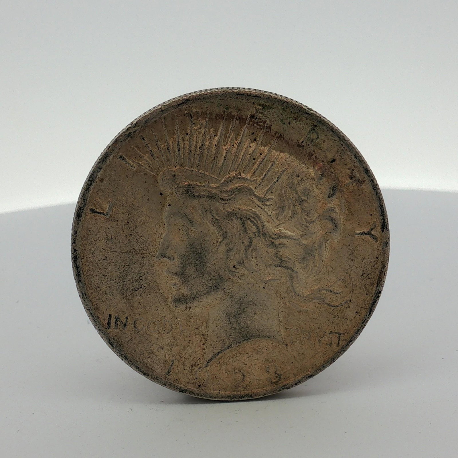 US 1923 Peace Silver Dollar: This US 1923 Peace silver dollar was struck at the Philadelphia Mint. Composed of 0.900 silver and 0.100 copper, the coin features the standard Peace dollar design types on both the obverse and