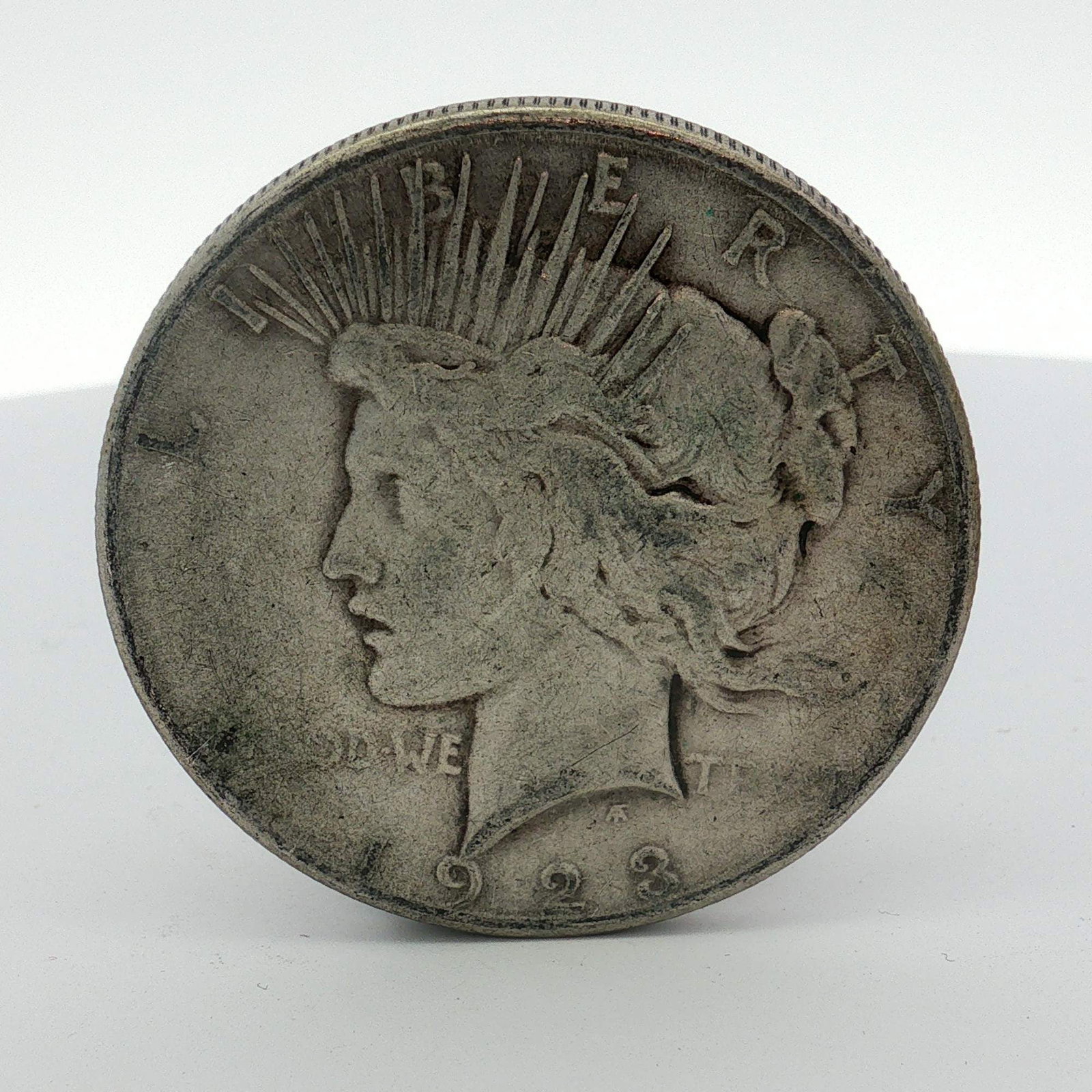 US 1923-S Peace Silver Dollar: This United States Peace silver dollar is dated 1923 and bears the S mint mark for the San Francisco Mint. The coin features the Peace dollar obverse and reverse designs. Struck in 90 percent silver