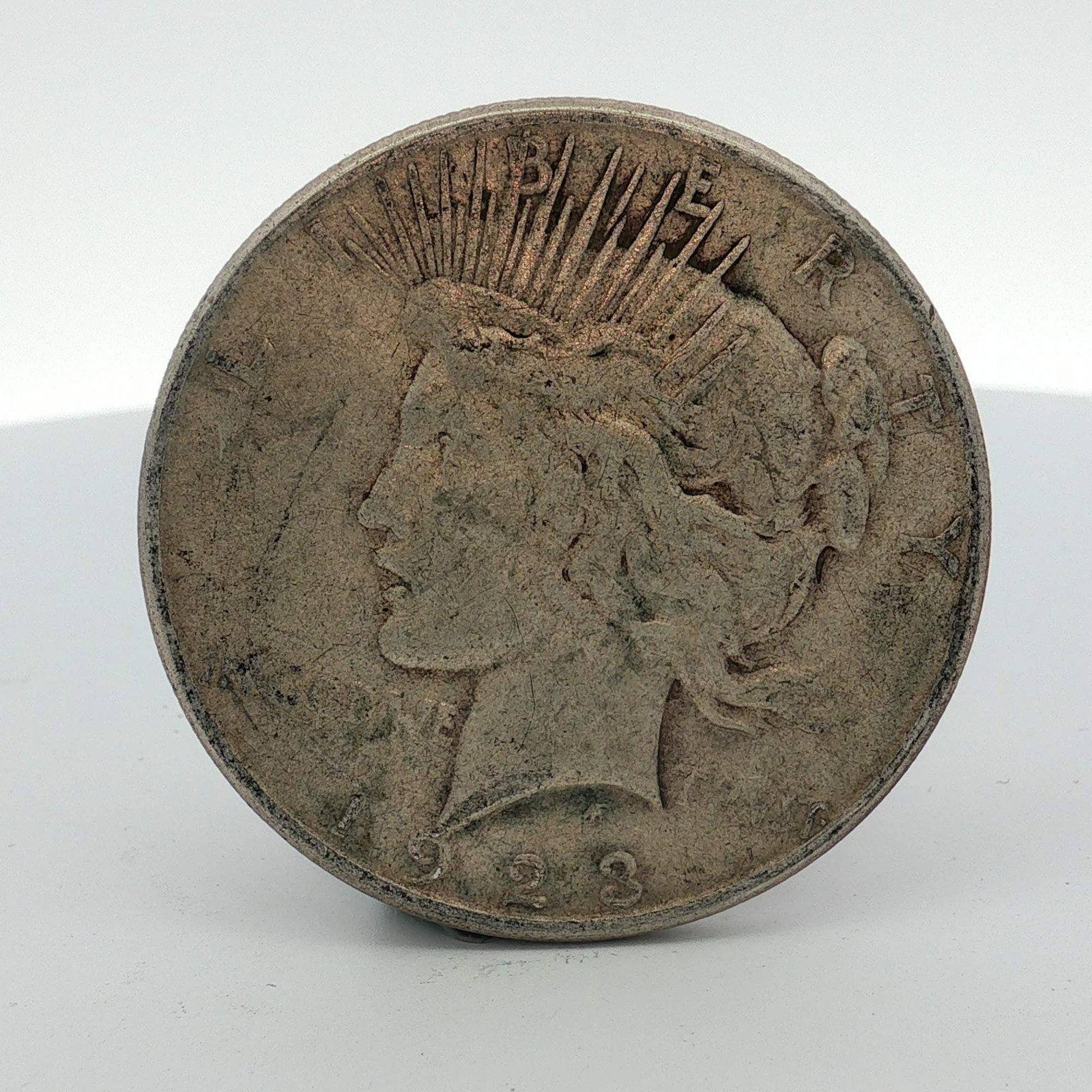 US 1923-S Peace Silver Dollar: This US 1923-S Peace silver dollar is composed of 0.900 fine silver. The obverse features the Peace dollar design with the date 1923 and inscriptions LIBERTY and IN GOD WE TRVST. The reverse displays