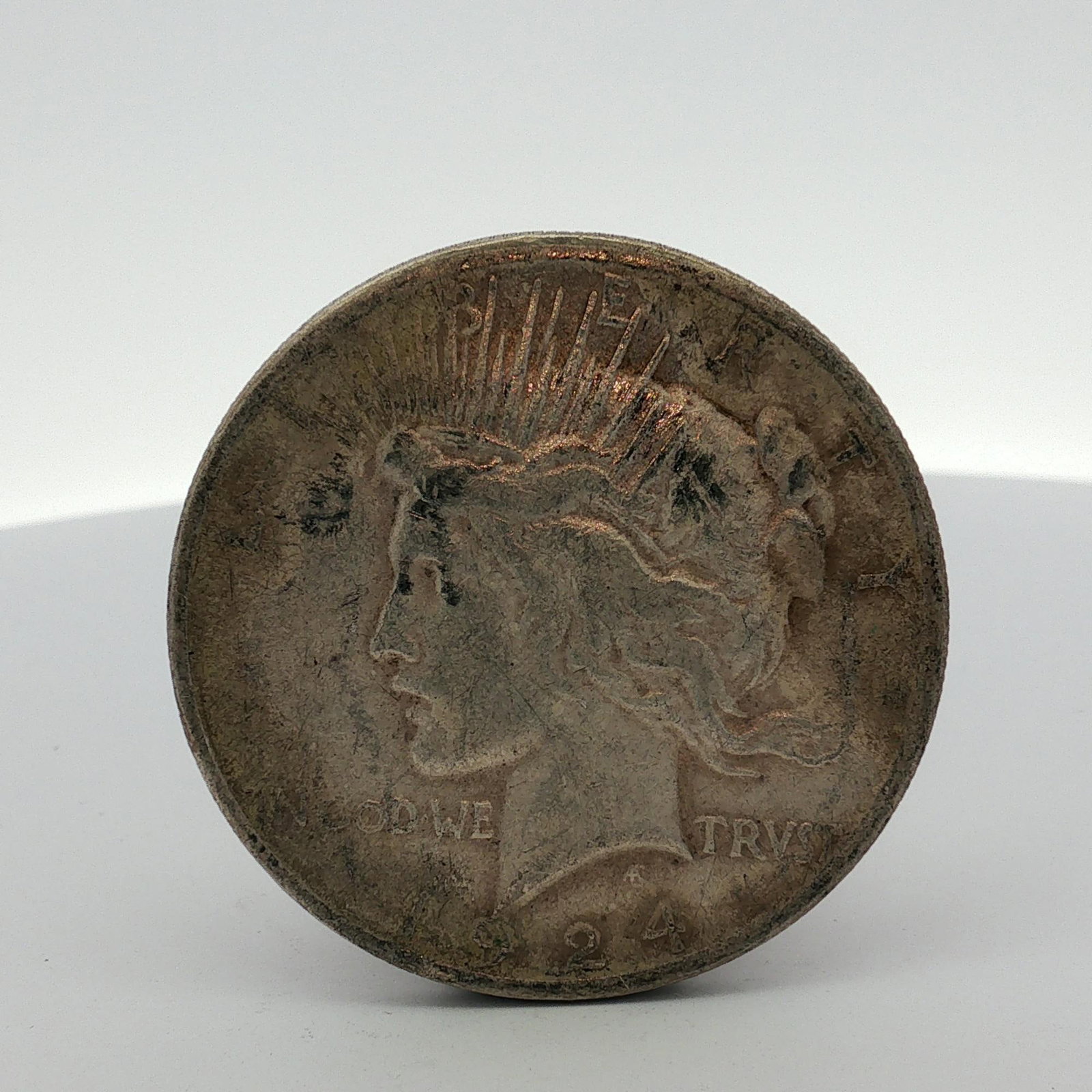 US 1924 Peace Silver Dollar: This US 1924 Peace silver dollar is composed of 90 percent silver and 10 percent copper. The obverse features the Peace Dollar obverse design with the date 1924 and the inscriptions LIBERTY and IN