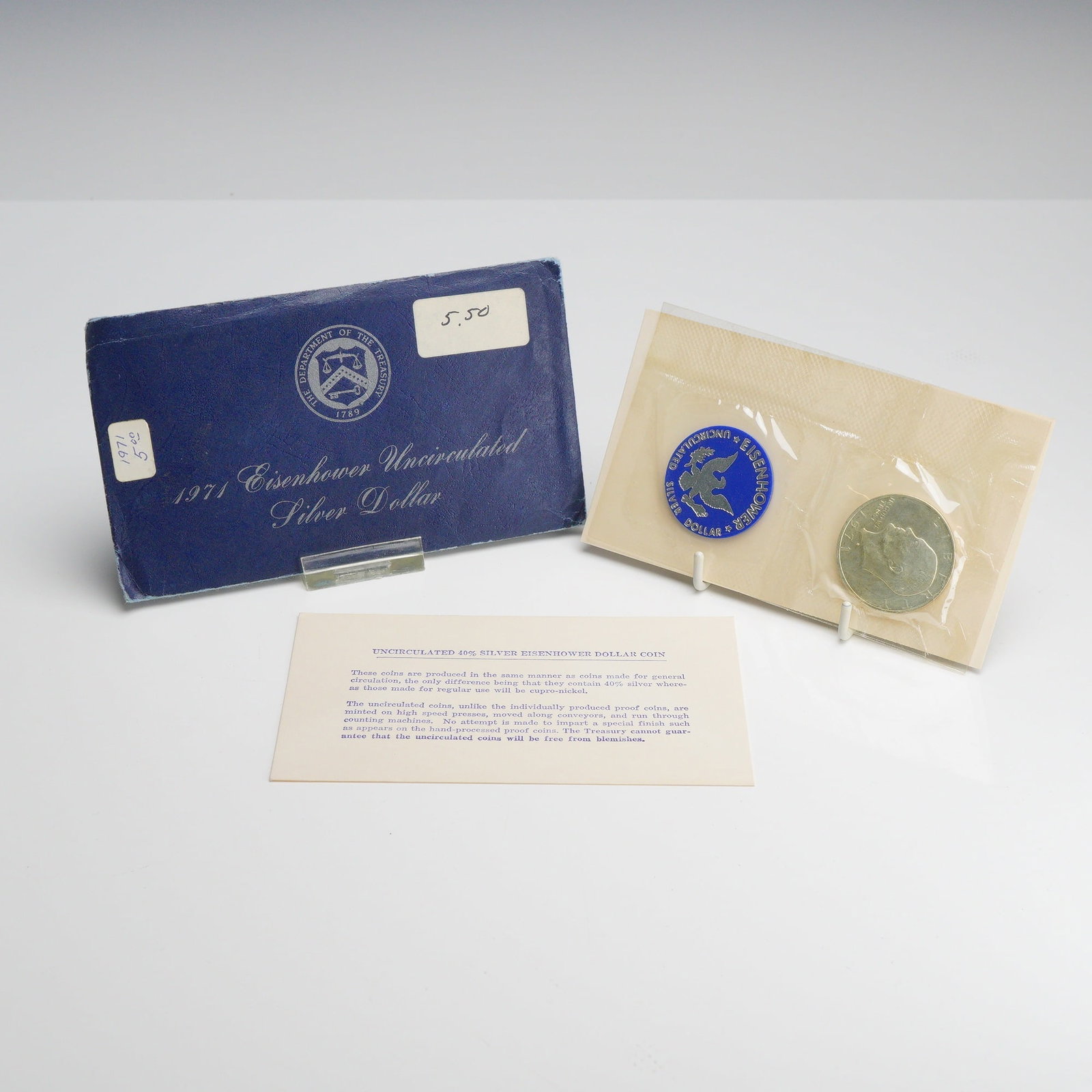 1971-S US Mint Eisenhower 40% Silver Dollar Uncirculated in Blue Envelope: This uncirculated 1971-S Eisenhower 40% silver dollar was produced at the San Francisco Mint and is presented in its original government packaging. The coin features the S mint mark on the obverse