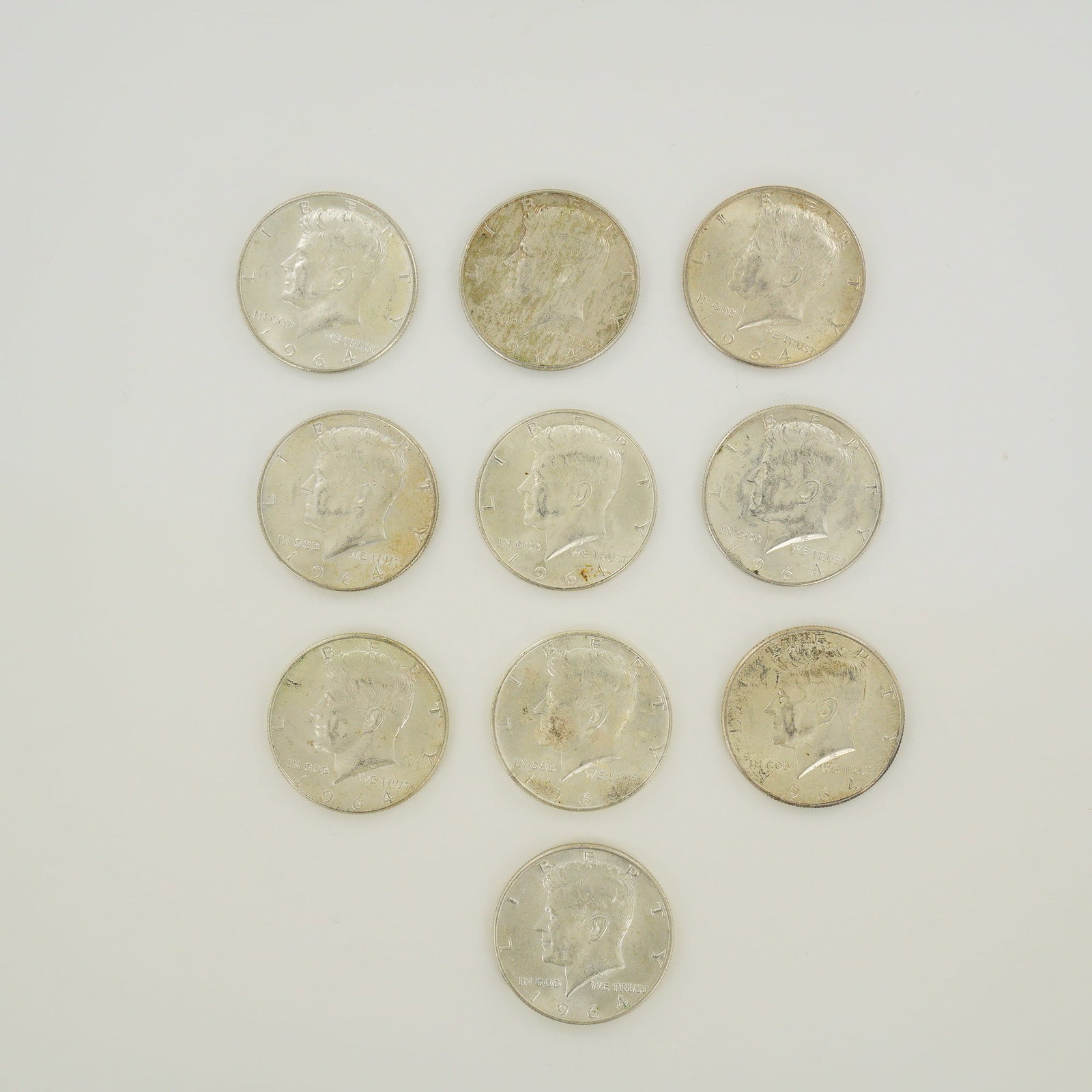 A Collection of US 1964 Kennedy Half Dollars, $5.00 Face Value: This collection consists of US Kennedy Half Dollars dated 1964, representing a $5.00 face value. Struck in a 90% silver composition, each coin features the Kennedy obverse and the Presidential Seal re