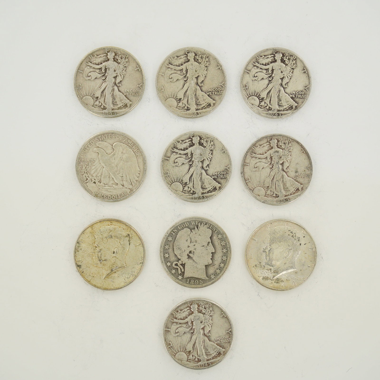 A Collection of US 90% Silver Half Dollars including Barber, Walking Liberty, and Kennedy Types (1 of 2)
