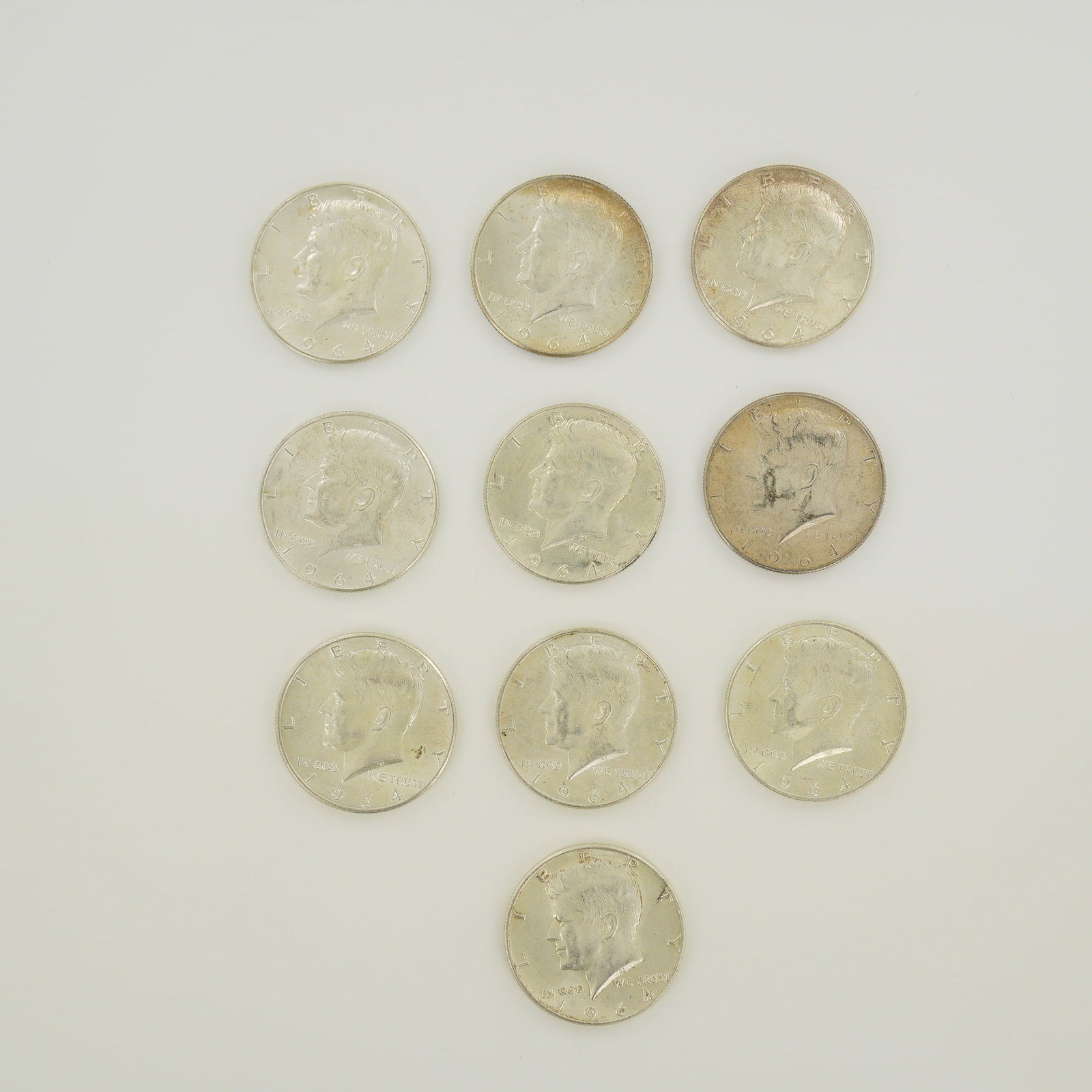 A Group of US 1964 Kennedy Half Dollars $5.00 Face Value: A group of US 1964 Kennedy half dollars representing a $5.00 face value. These coins are struck in 90 percent silver and 10 percent copper with a reeded edge. The obverse and reverse follow the standa